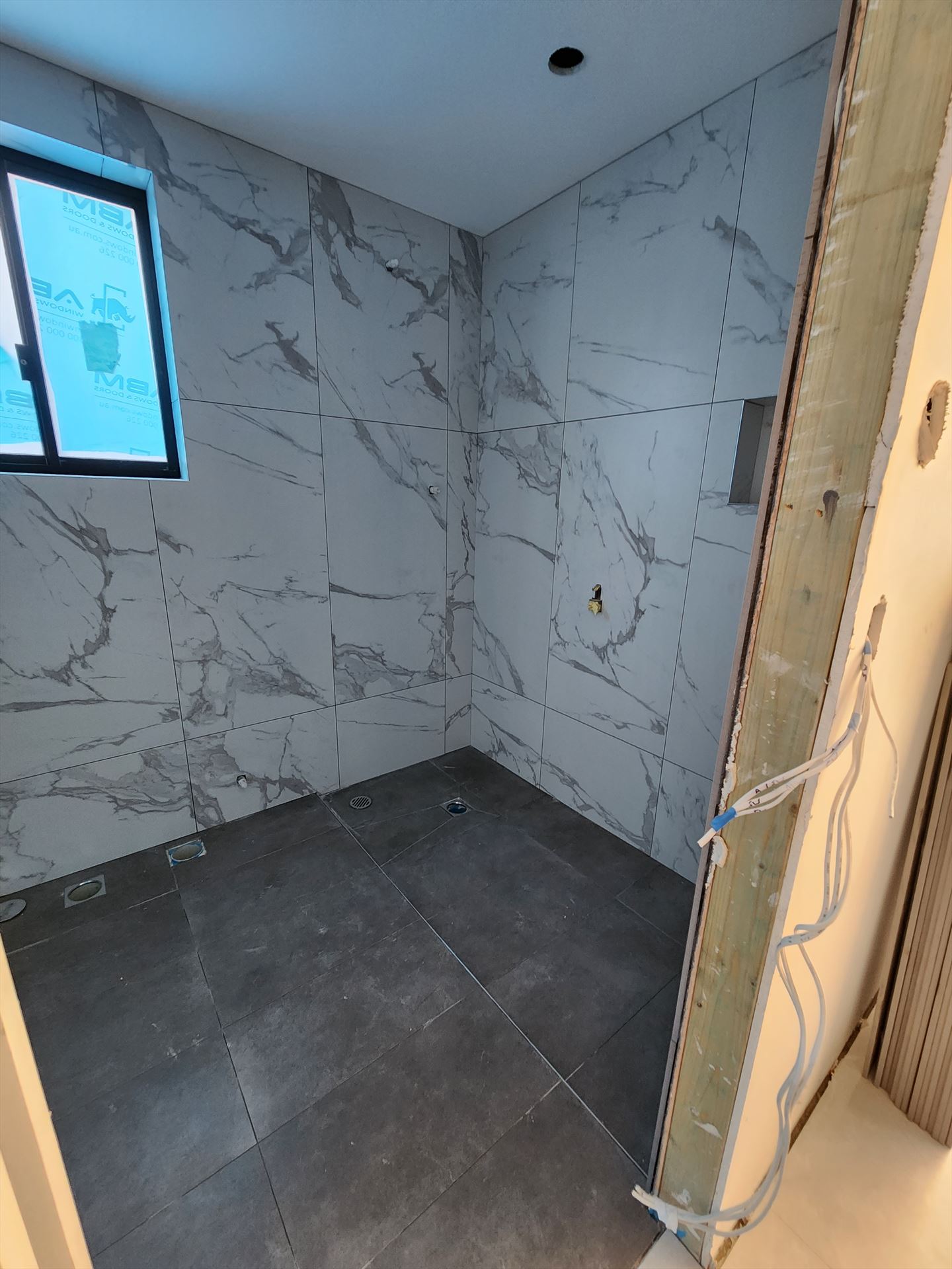 Bathroom before frameless shower screen install in Girraween