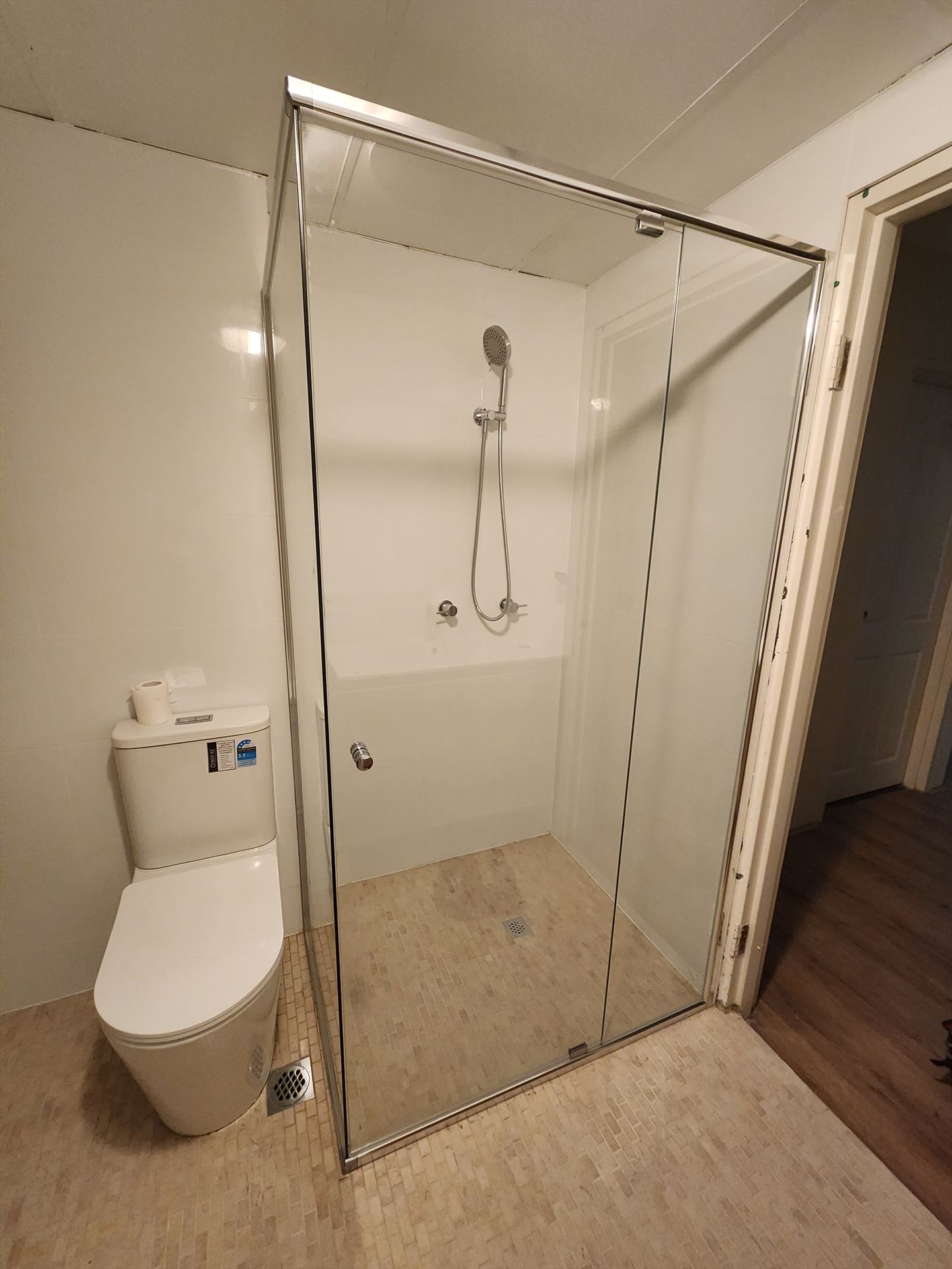 semi shower screen with chrome hardware installed in Artarmon by Showerland