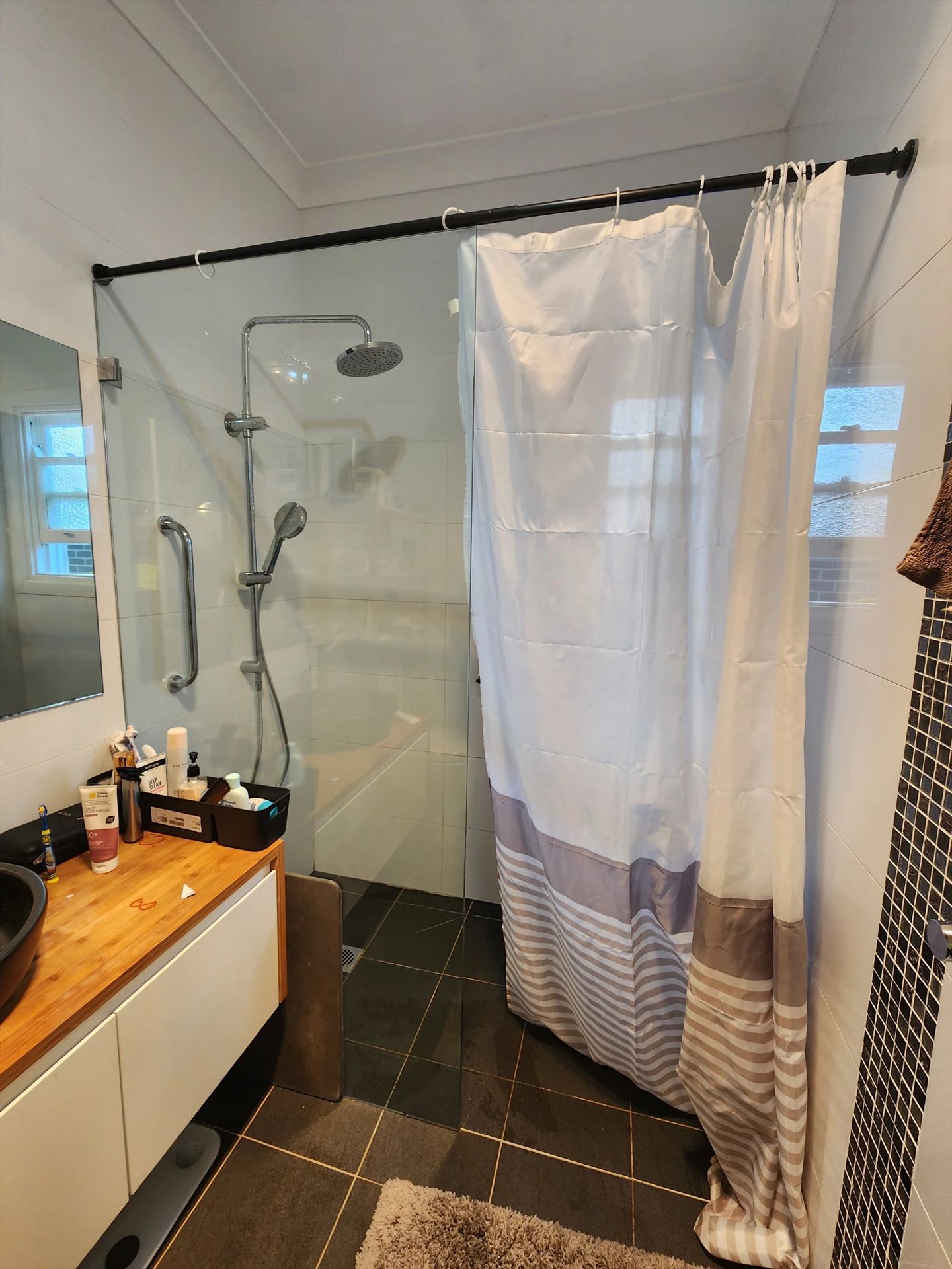 frameless shower screen with black hardware installed in Melrose Park by Showerland