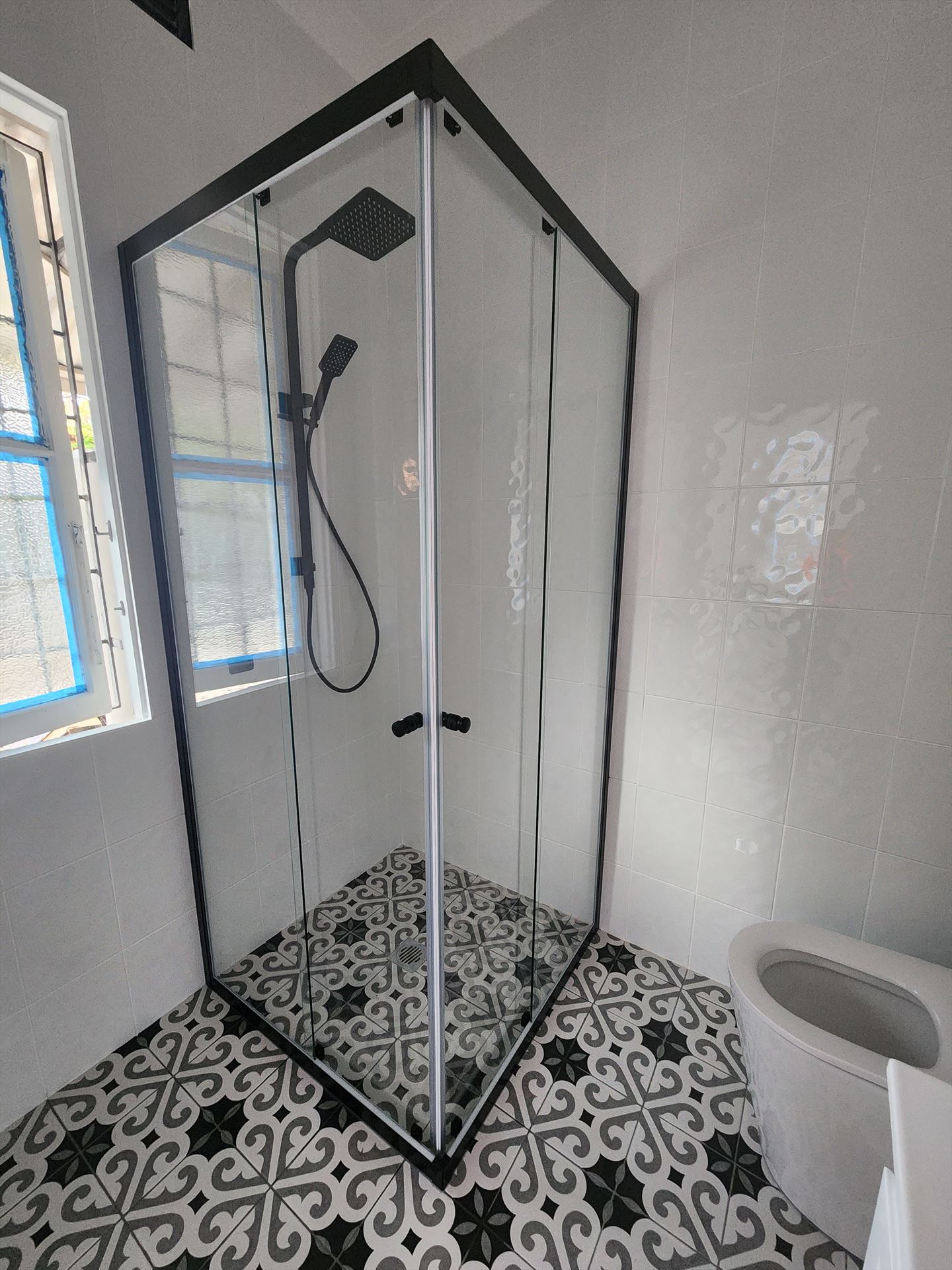 semi shower screen with black hardware installed in Strathfield by Showerland