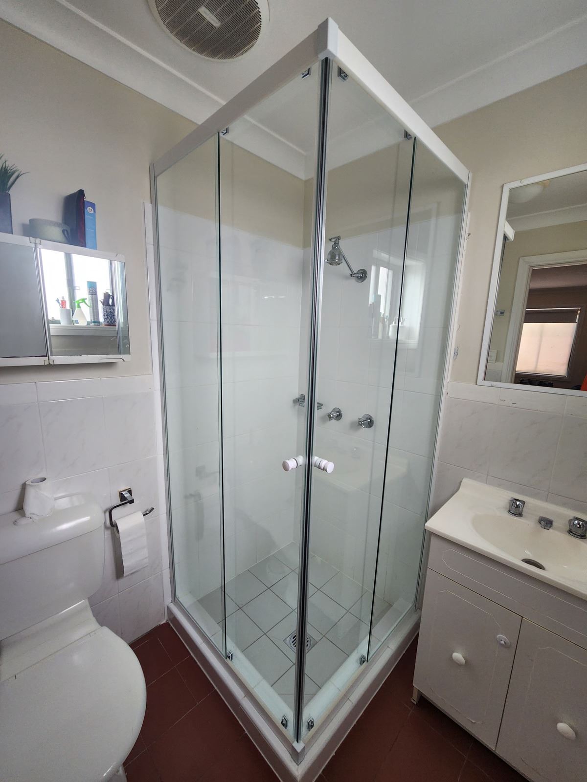 semi shower screen with white hardware installed in Winston Hills by Showerland