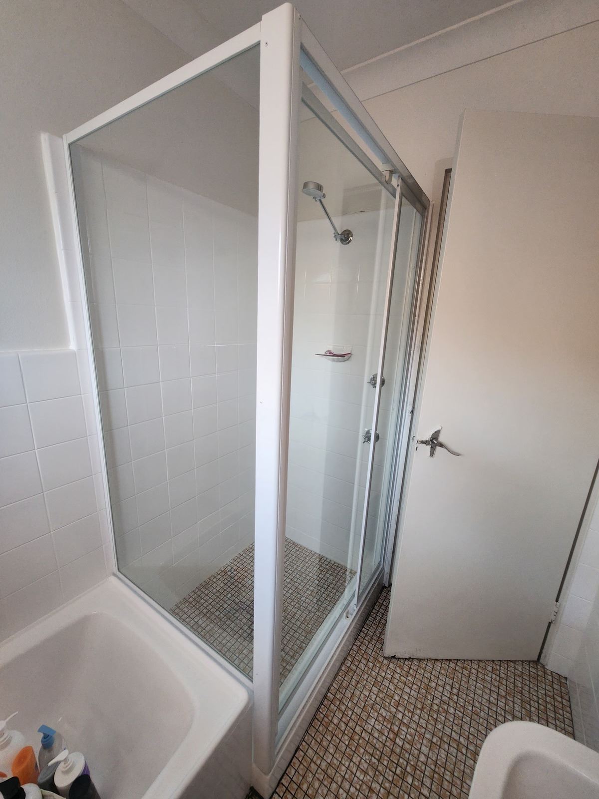 fully shower screen with white hardware installed in Belmore by Showerland