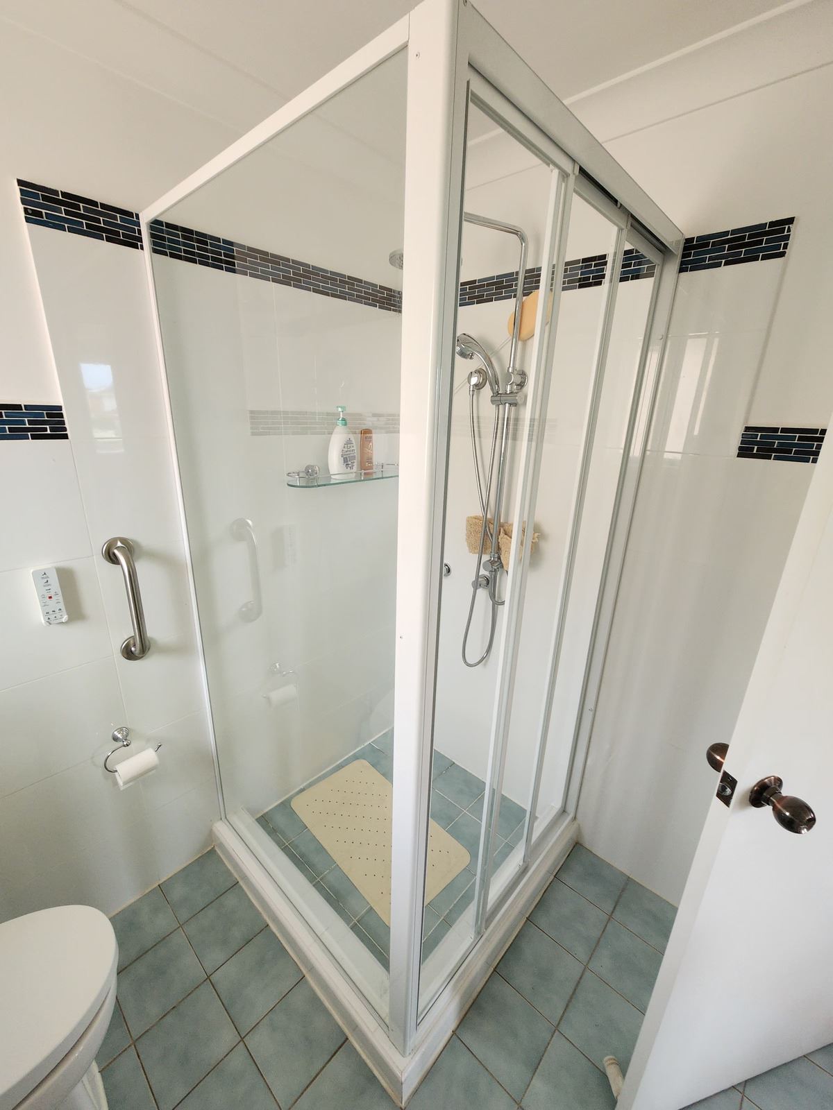 fully shower screen with white hardware installed in Glenwood by Showerland