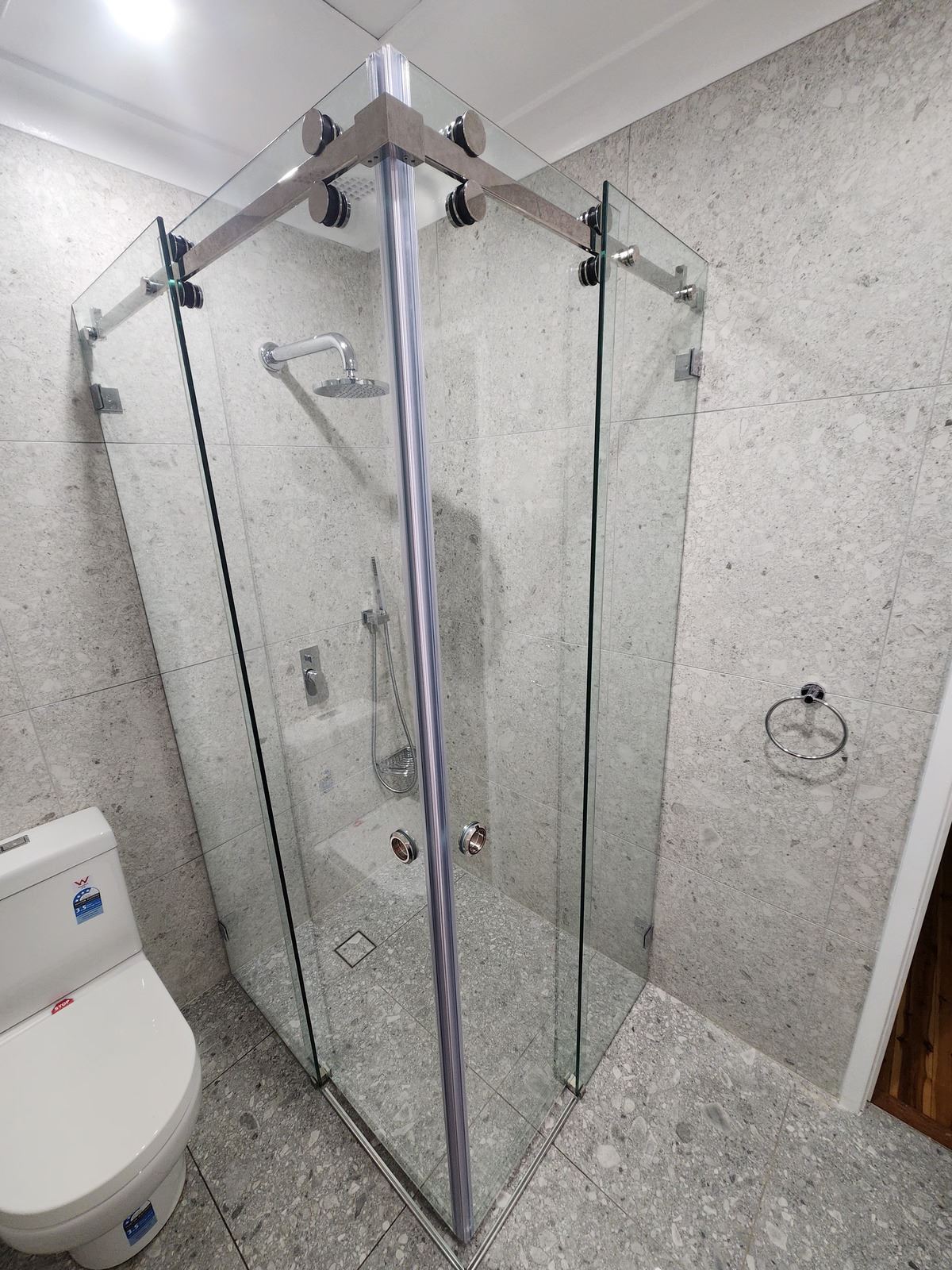 frameless shower screen with chrome hardware installed in Winston Hills by Showerland