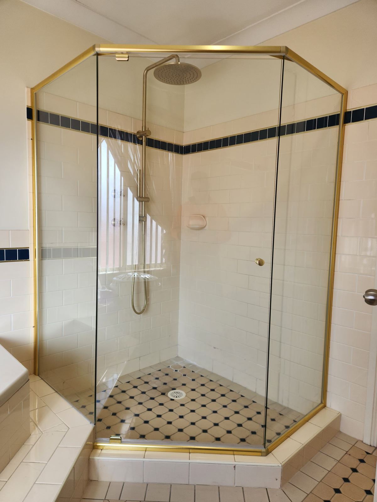 semi shower screen with gold hardware installed in Quakers Hill by Showerland