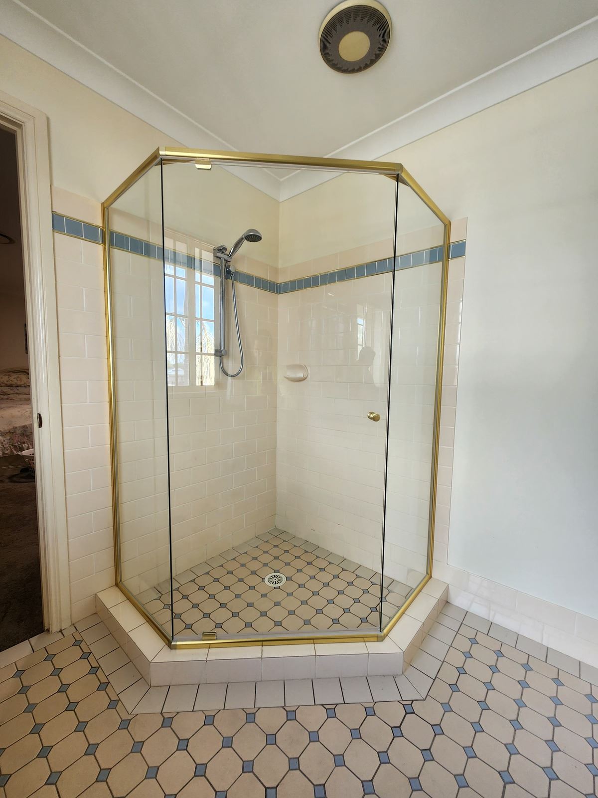 semi shower screen with gold hardware installed in Quakers Hill by Showerland