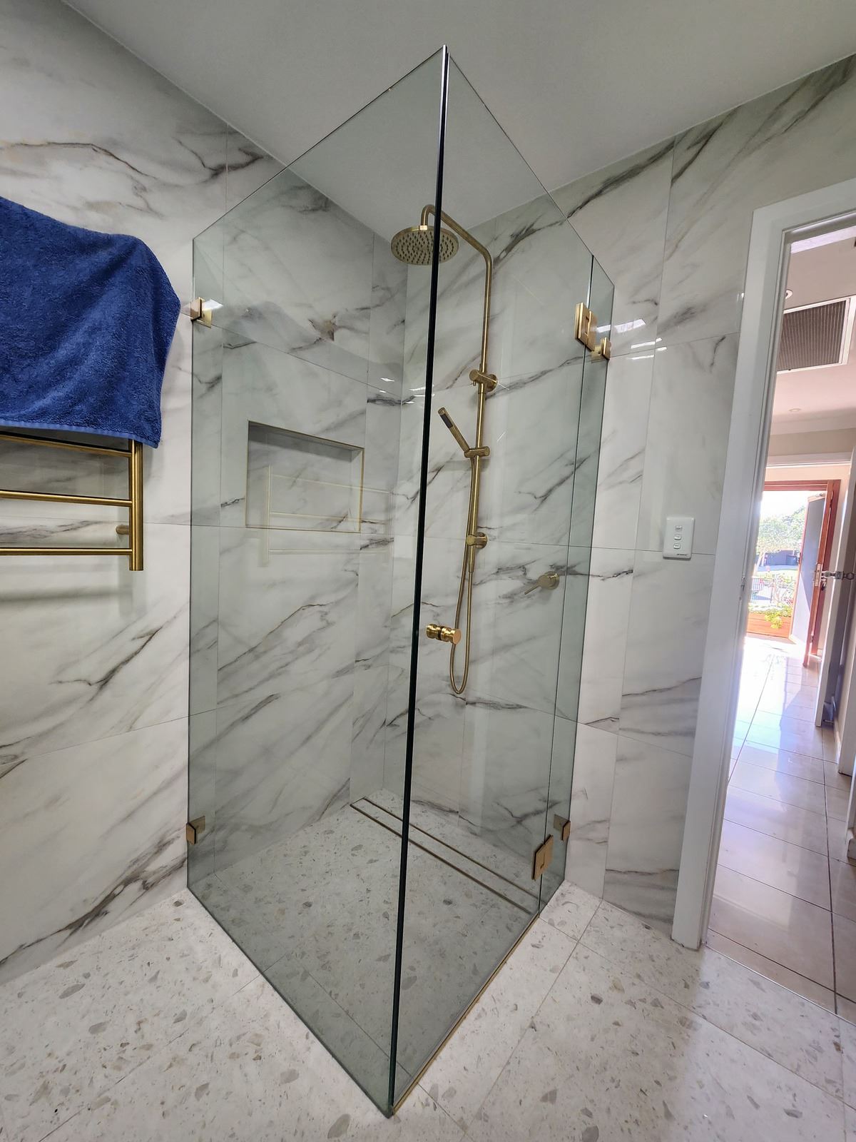 frameless shower screen with gold hardware installed in Marayong by Showerland