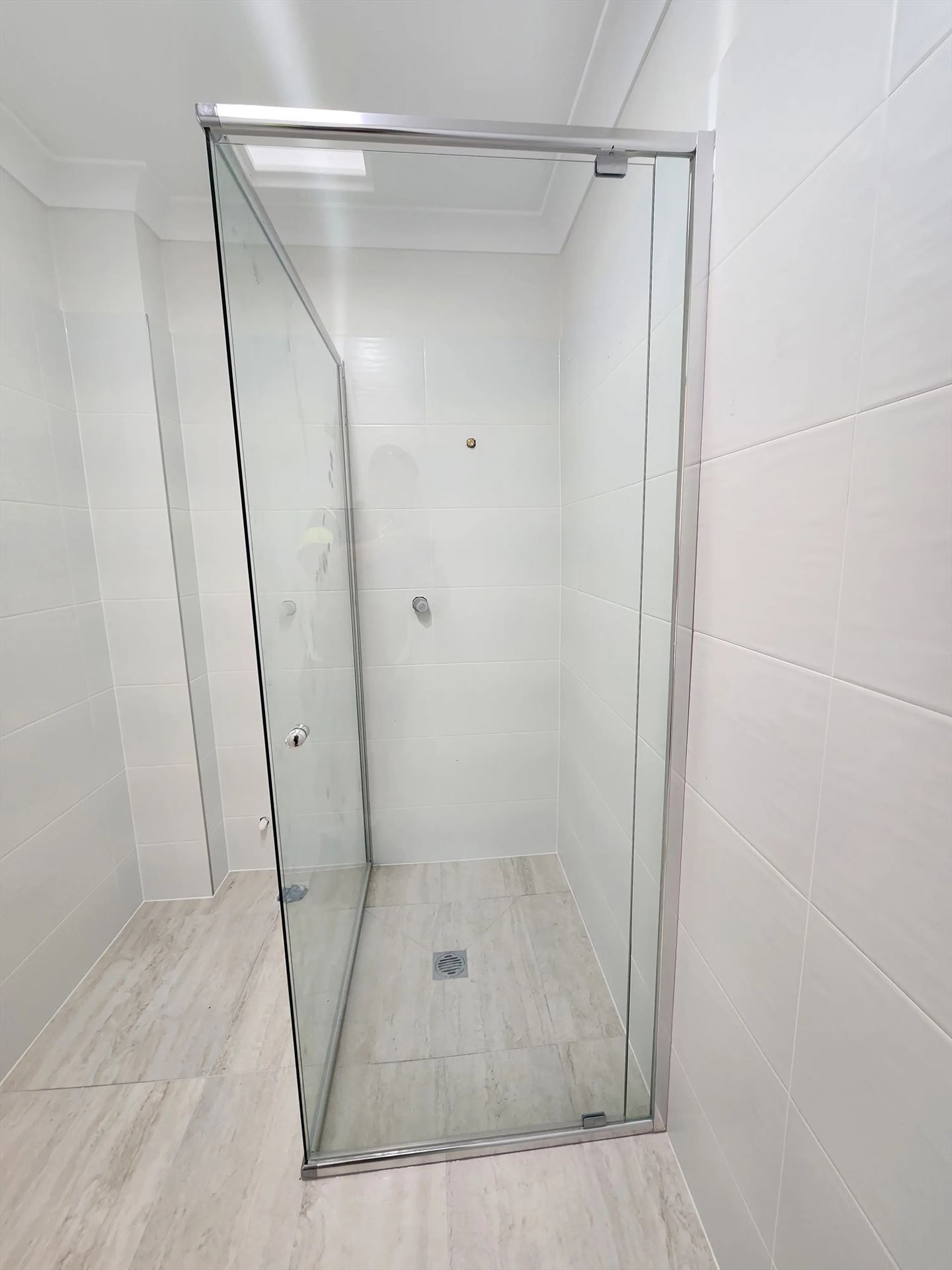 semi shower screen with chrome hardware installed in Westmead by Showerland