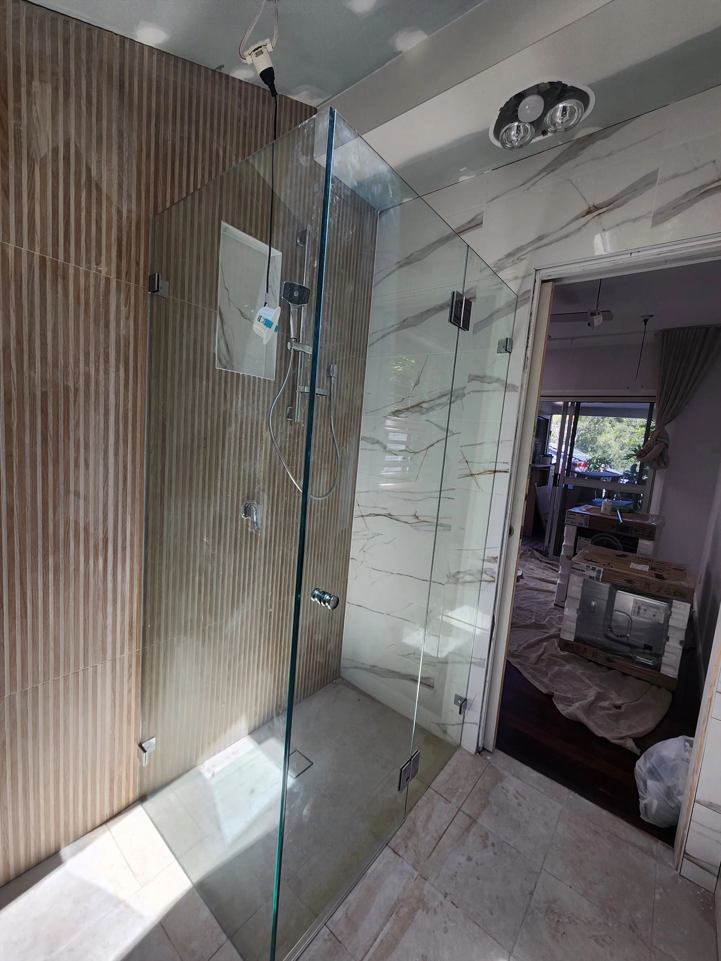frameless shower screen with chrome hardware installed in Newport by Showerland