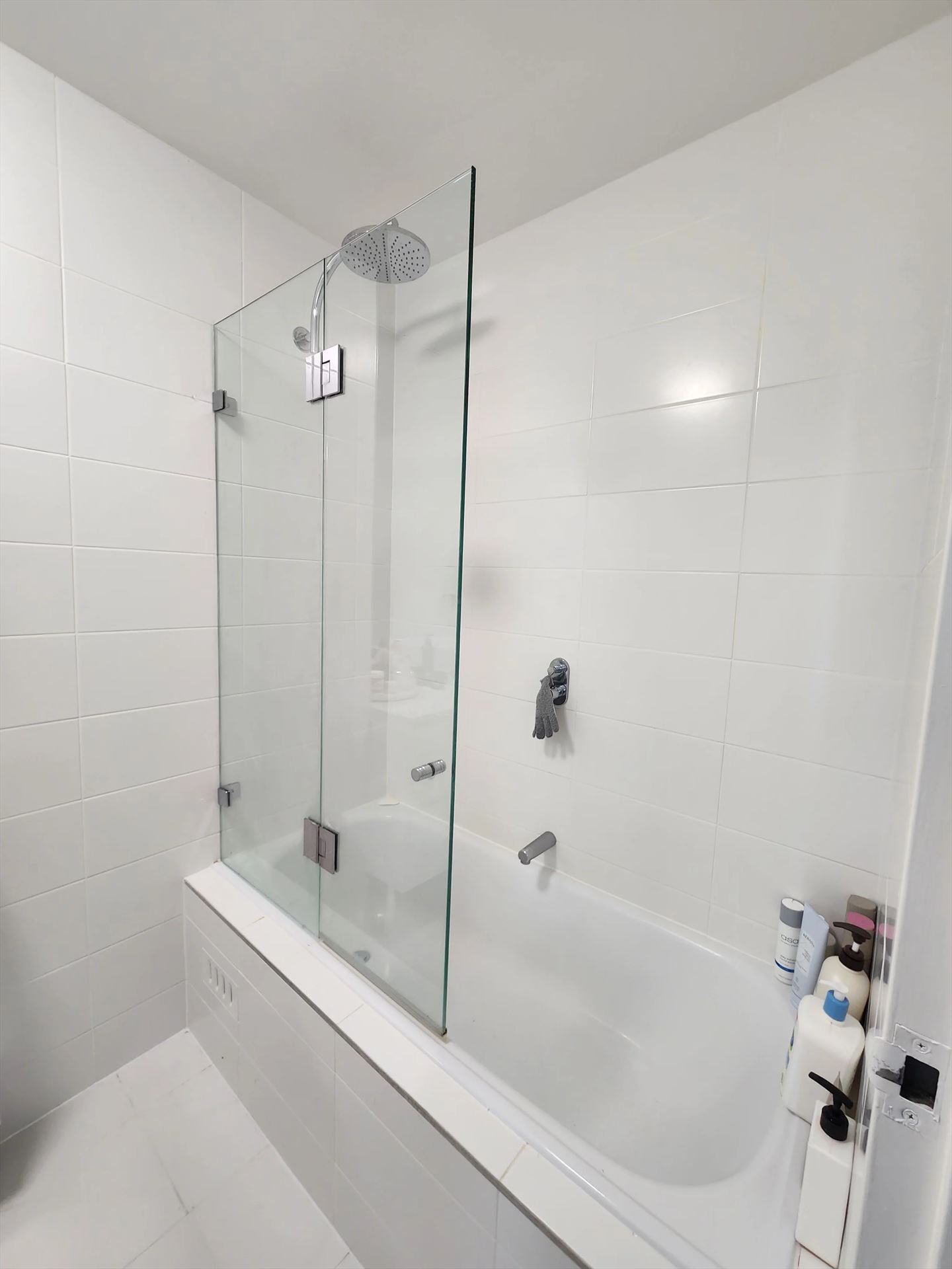 frameless shower screen with chrome hardware installed in Rosebery by Showerland