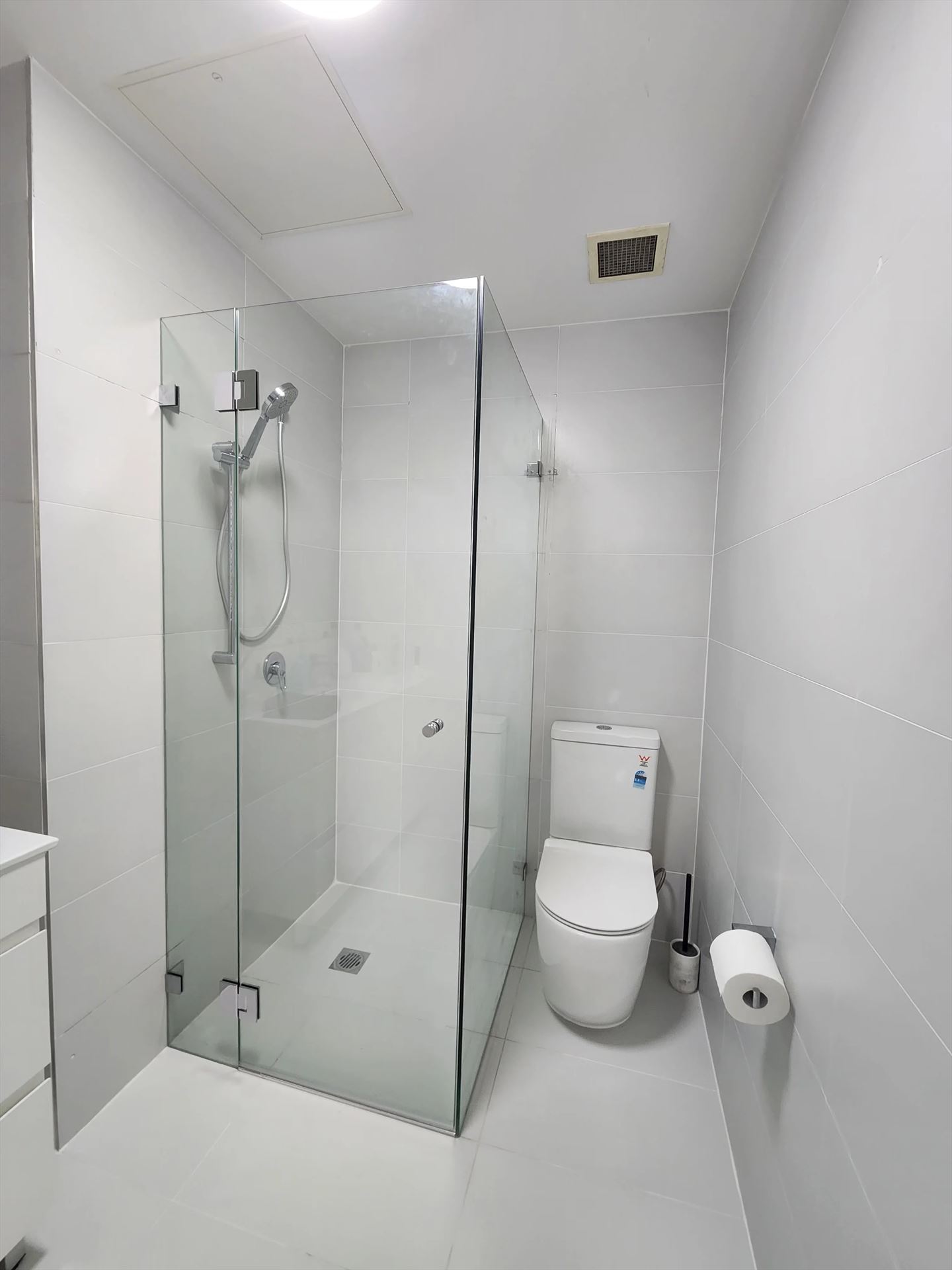 frameless shower screen with chrome hardware installed in Rosebery by Showerland