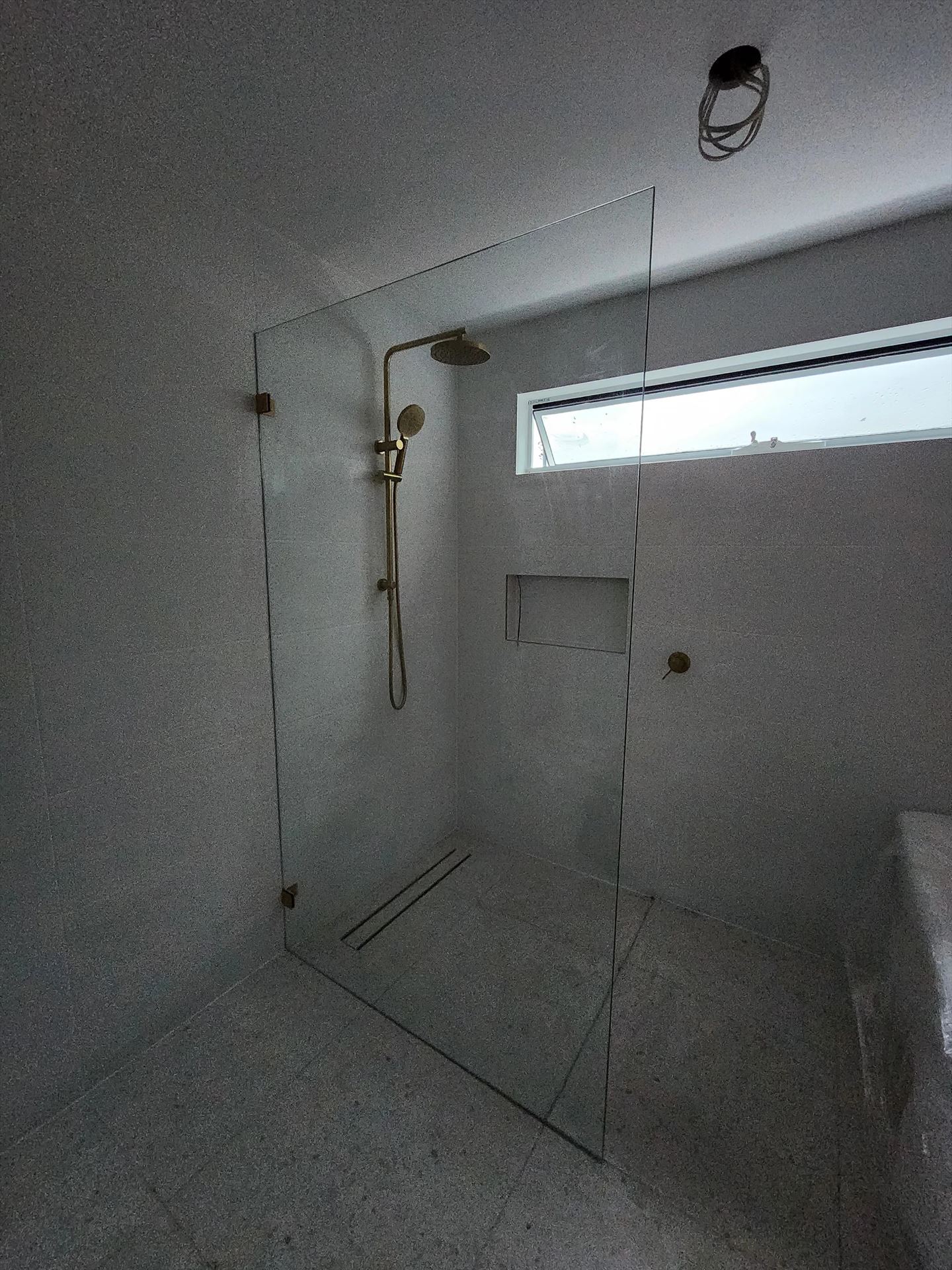 frameless shower screen with gold hardware installed in Woronora by Showerland