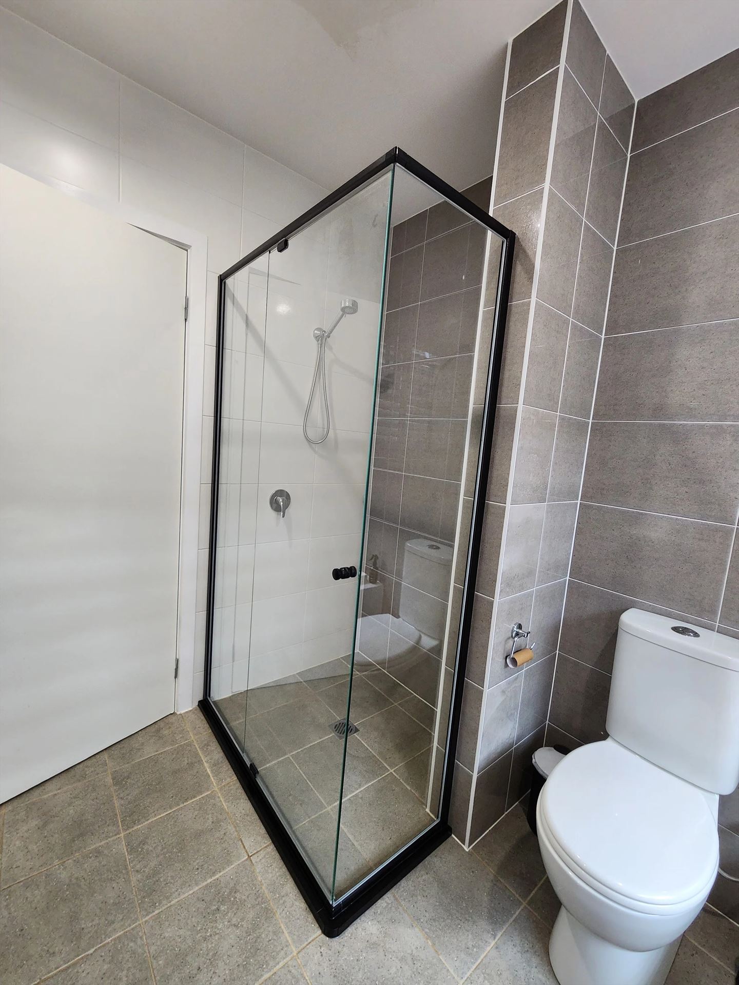 semi shower screen with black hardware installed in Box Hill by Showerland