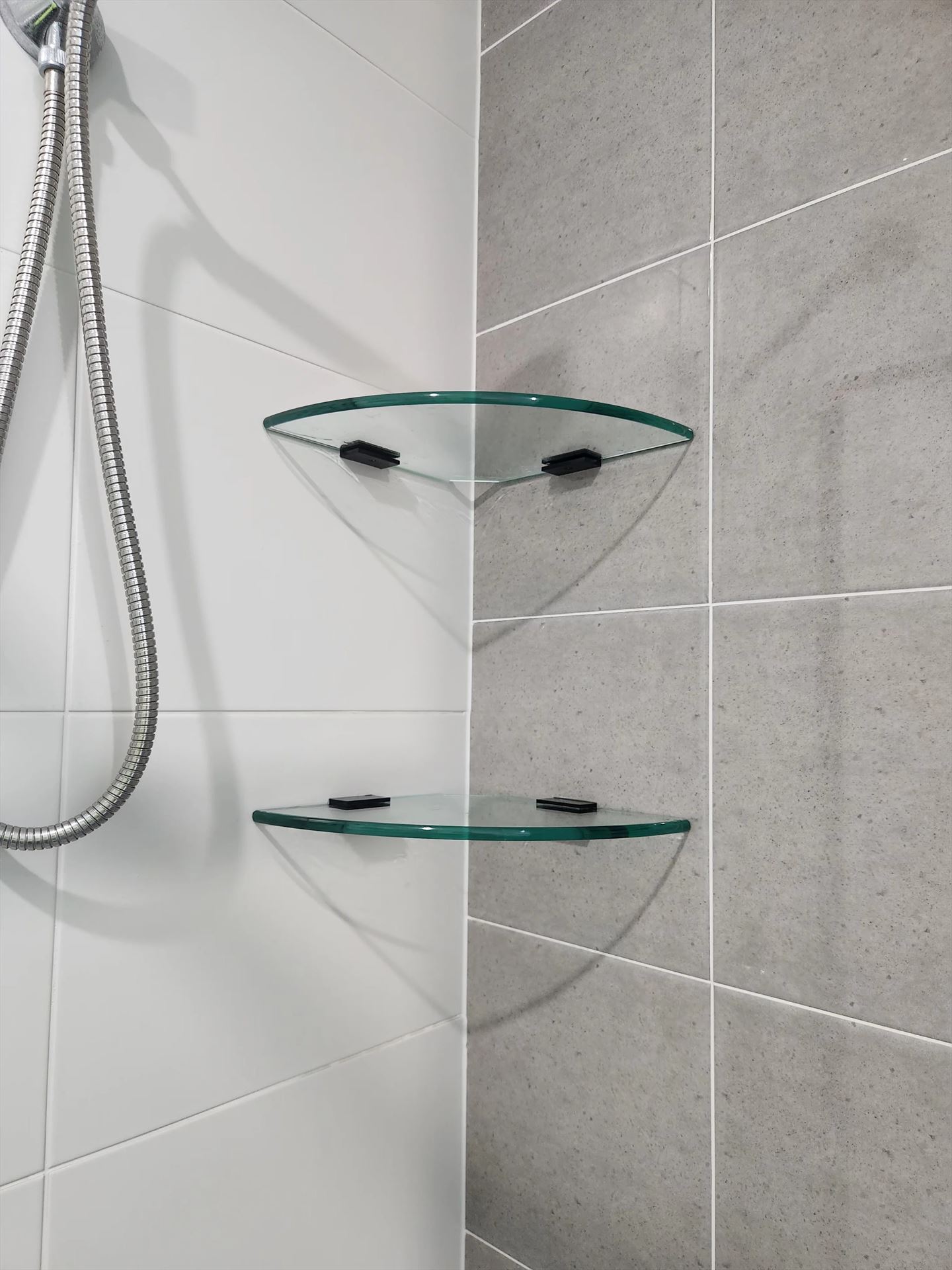 semi shower screen with black hardware installed in Box Hill by Showerland