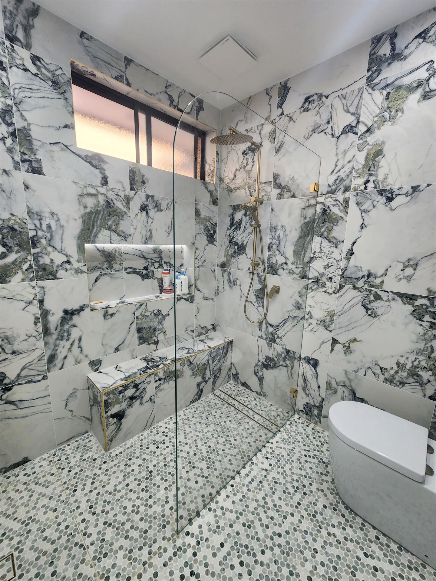 frameless shower screen with gold hardware installed in Eastlakes by Showerland