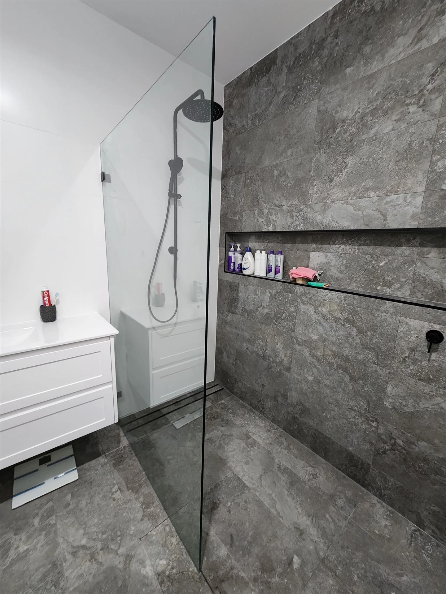 frameless shower screen with black hardware installed in Oakville by Showerland