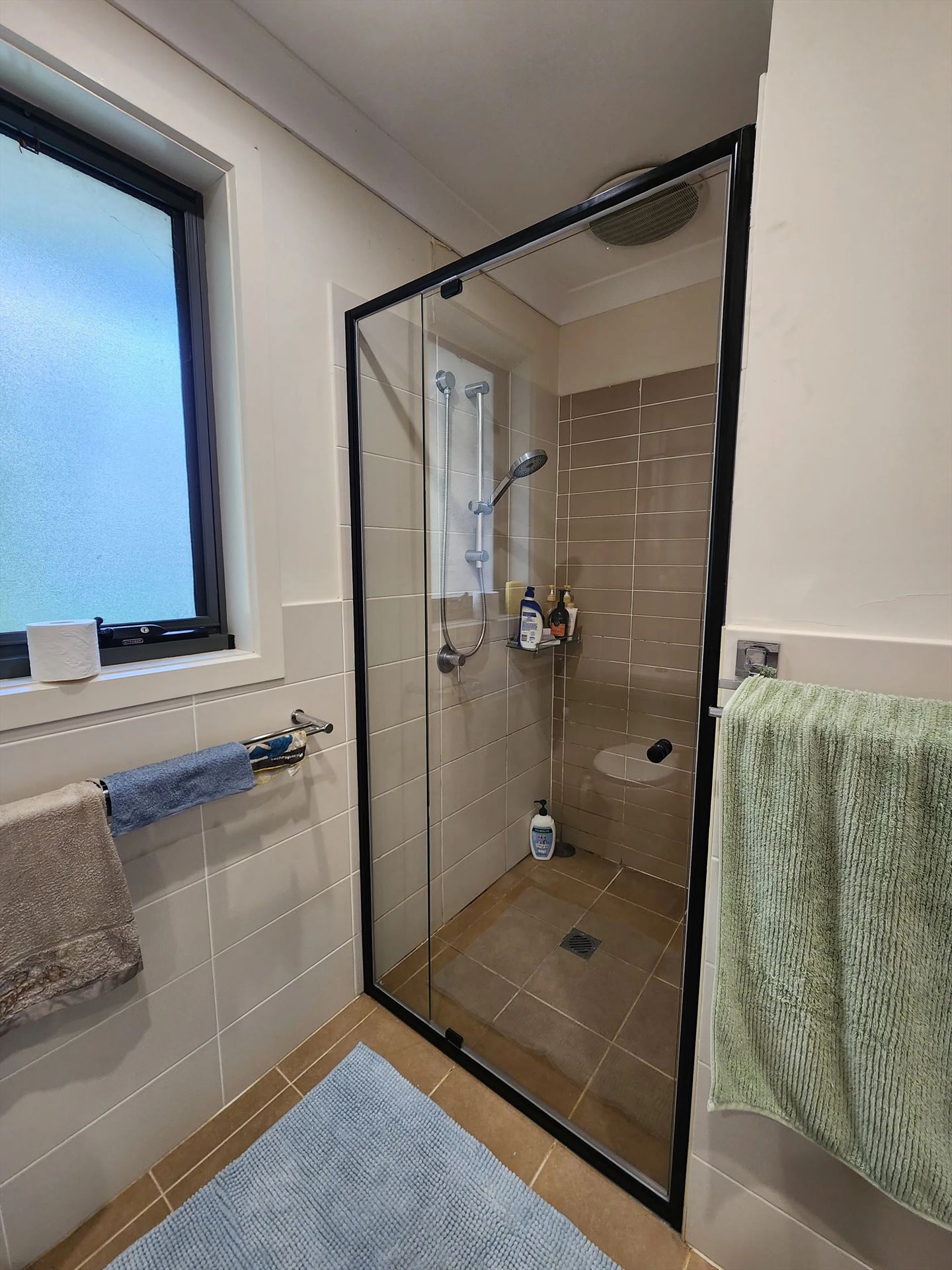 semi shower screen with black hardware installed in Lidcombe by Showerland