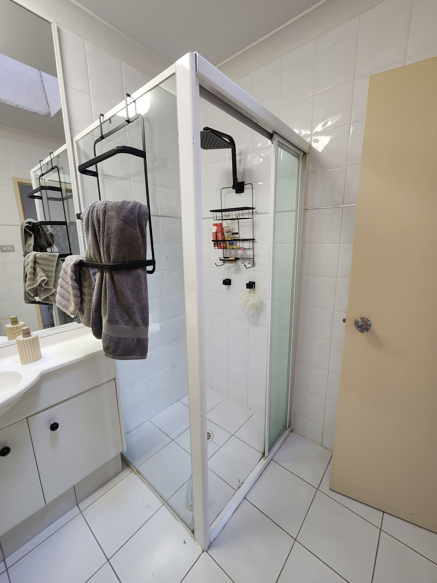 semi shower screen with black hardware installed in Ryde by Showerland