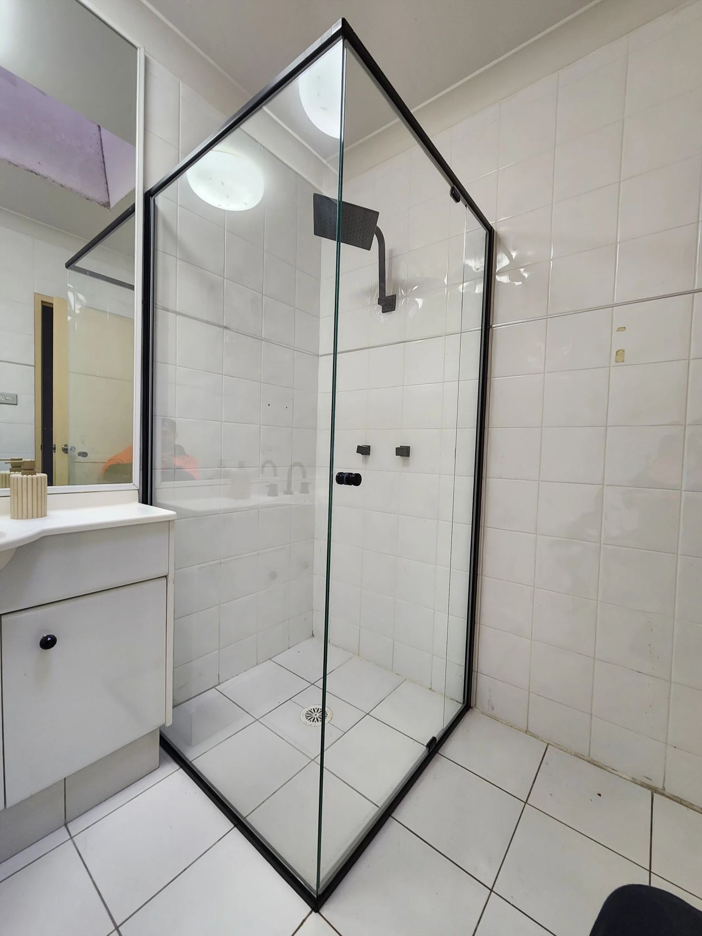 semi shower screen with black hardware installed in Ryde by Showerland
