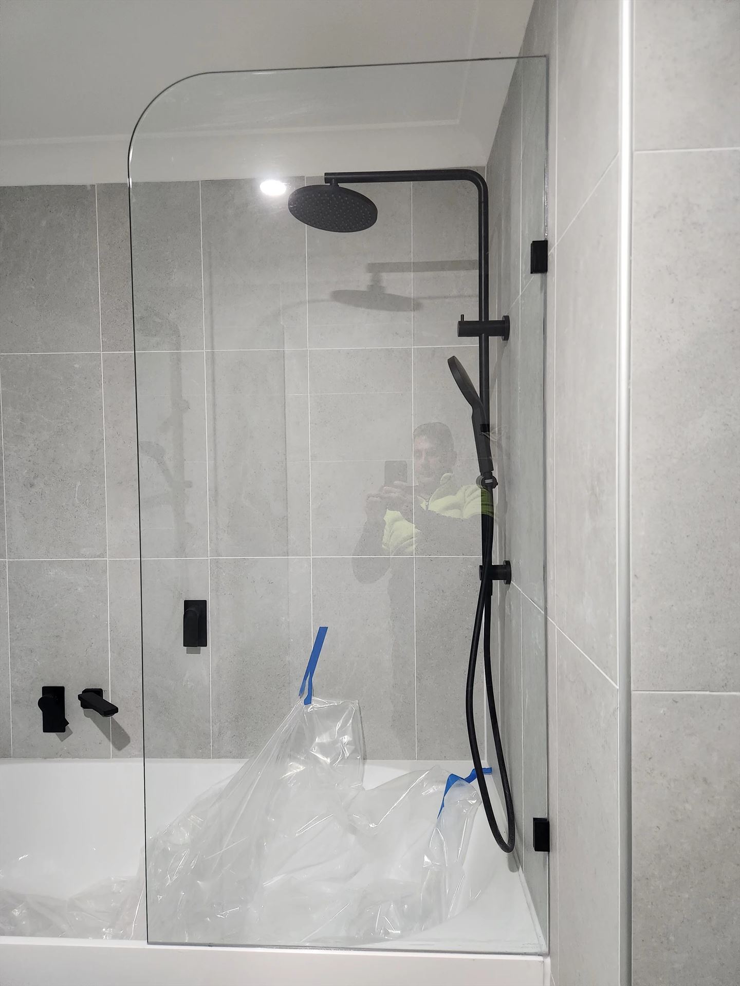 frameless shower screen with black hardware installed in Quakers Hill by Showerland