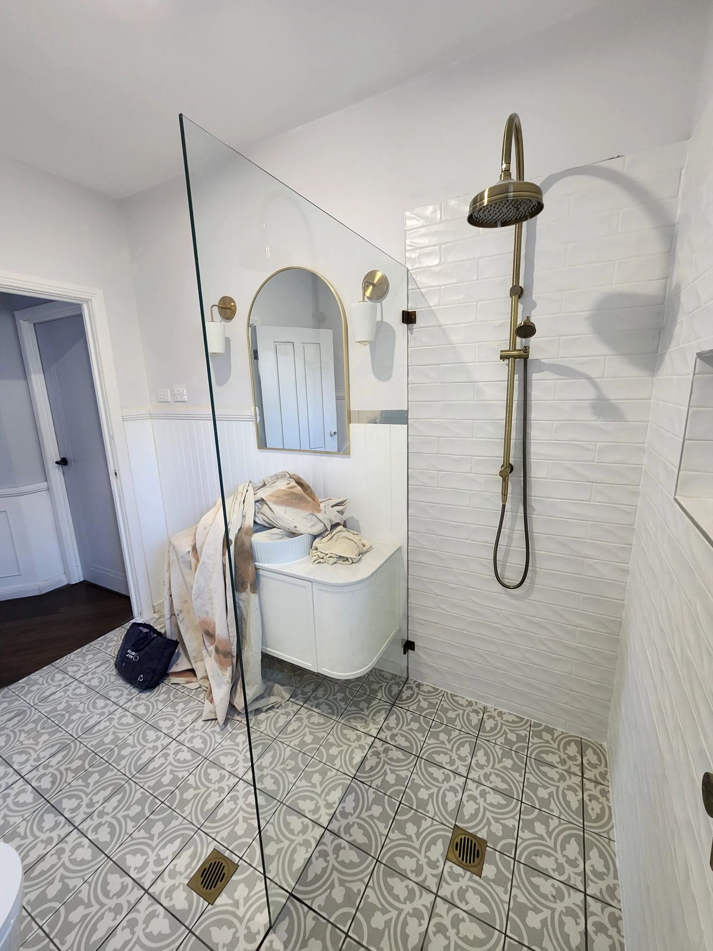 frameless shower screen with gold hardware installed in Peakhurst by Showerland