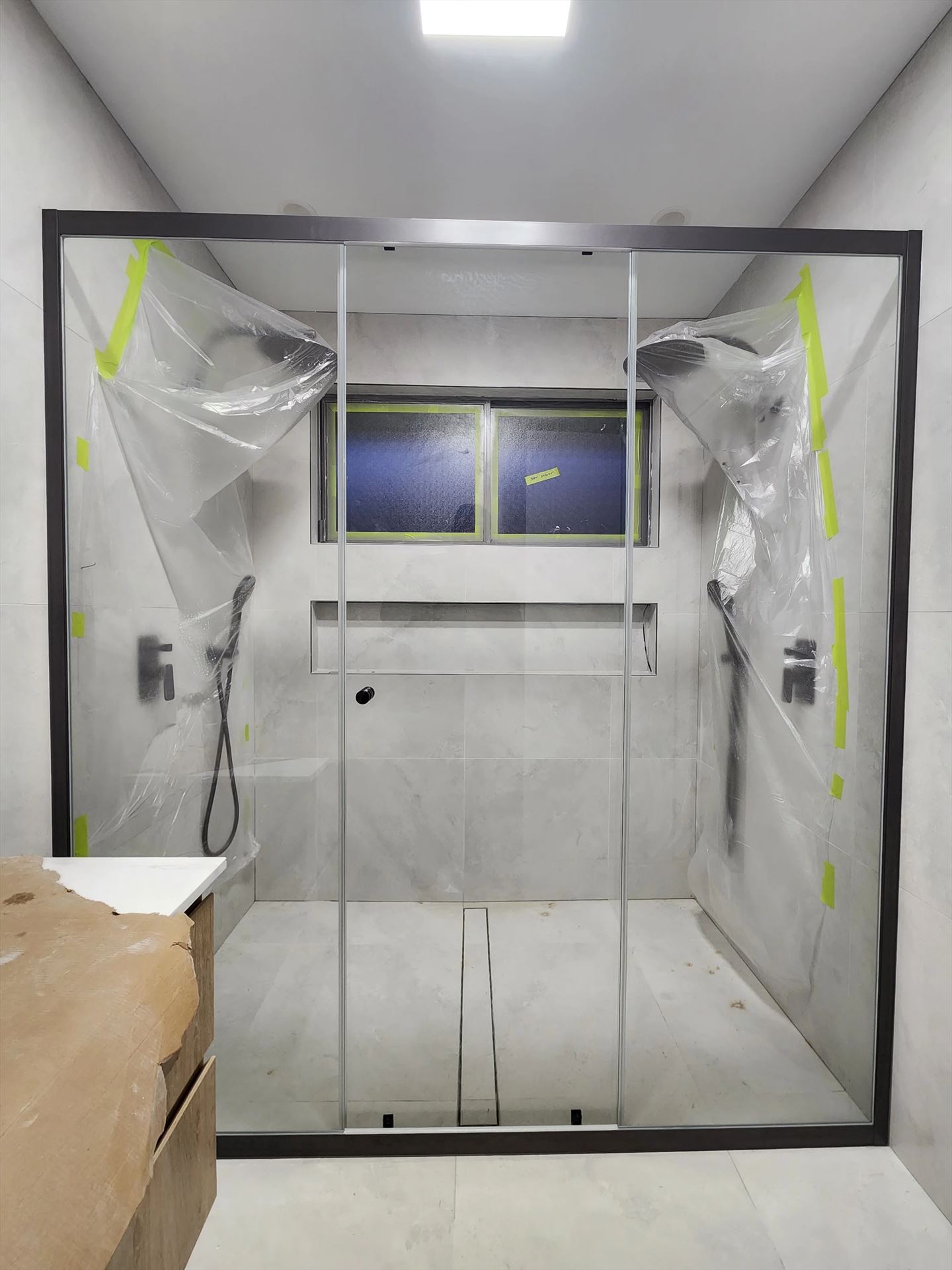semi shower screen with black hardware installed in Sydney by Showerland