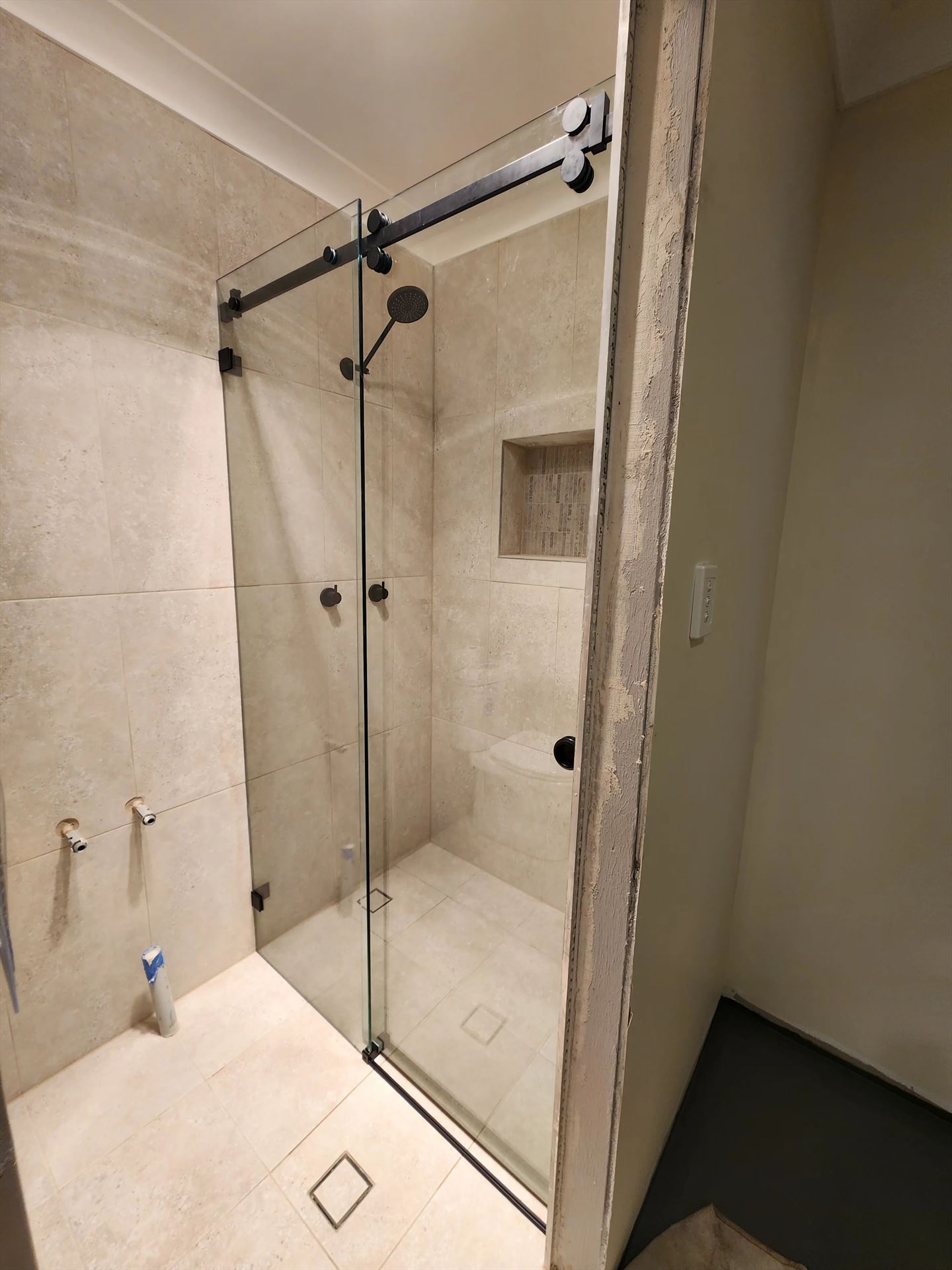 frameless shower screen with black hardware installed in Ingleburn by Showerland