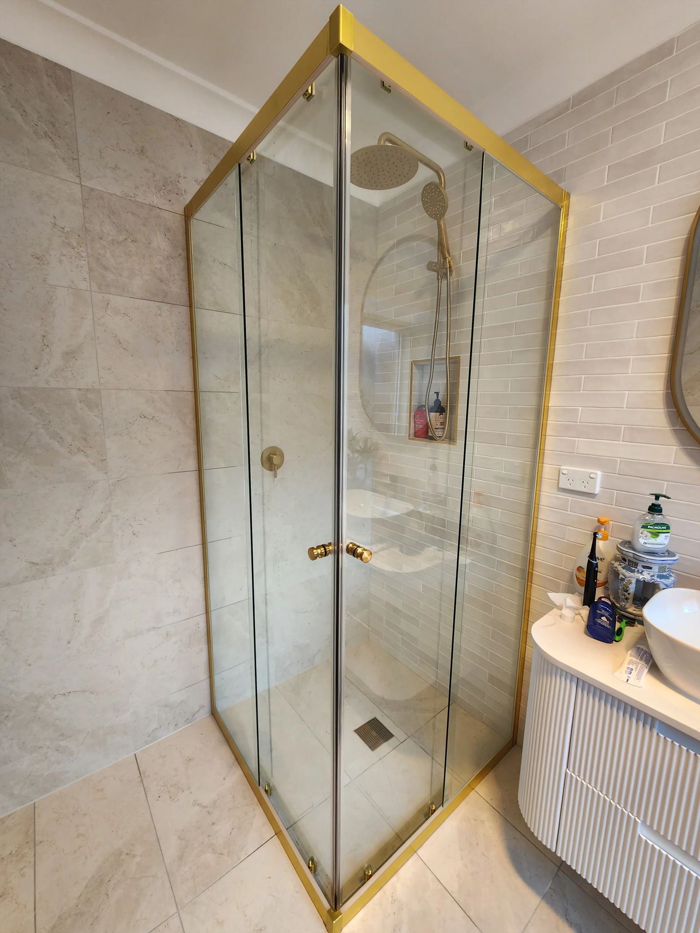 semi shower screen with gold hardware installed in Wattle Grove by Showerland