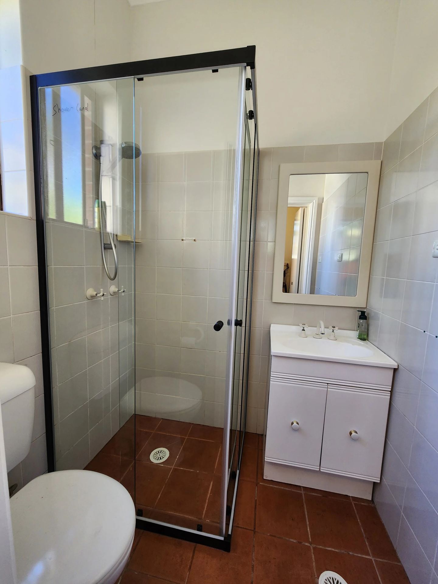 semi shower screen with black hardware installed in Ashfield by Showerland