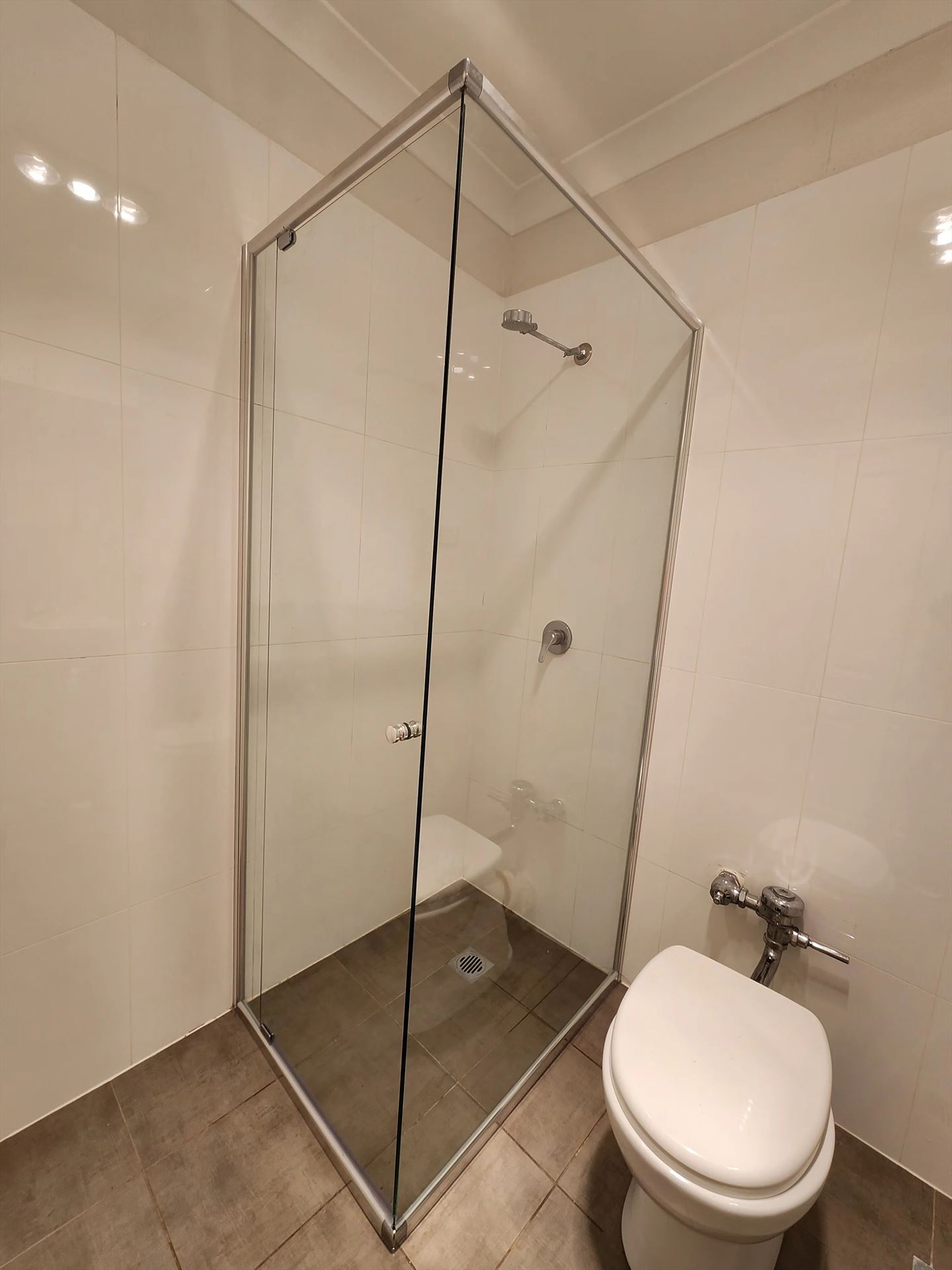 semi shower screen with chrome hardware installed in Elizabeth Bay by Showerland
