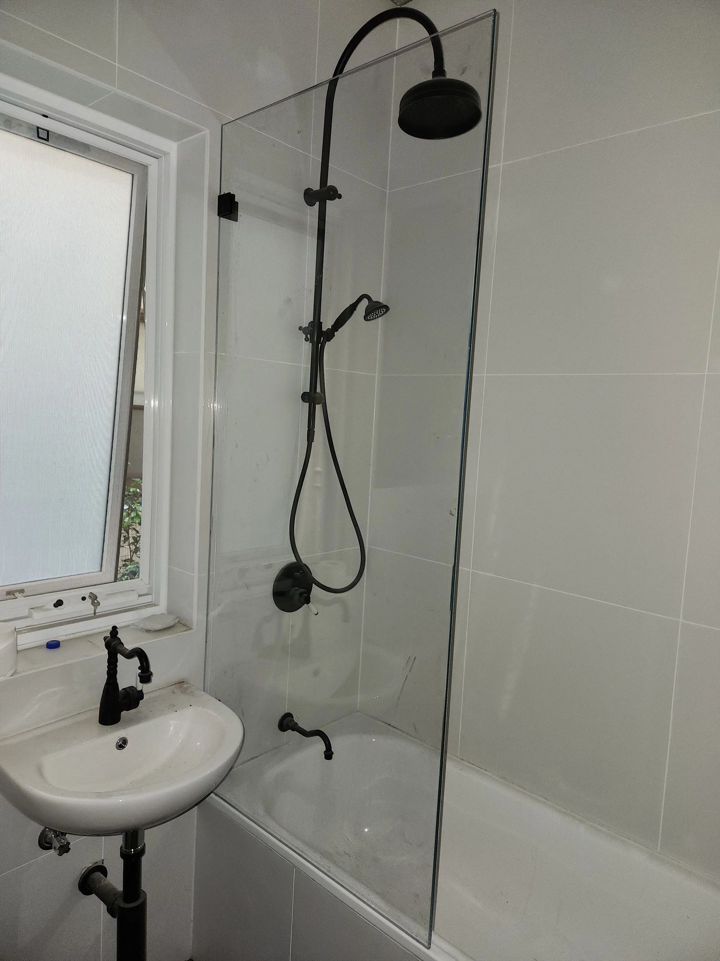 frameless shower screen with black hardware installed in Potts Point by Showerland