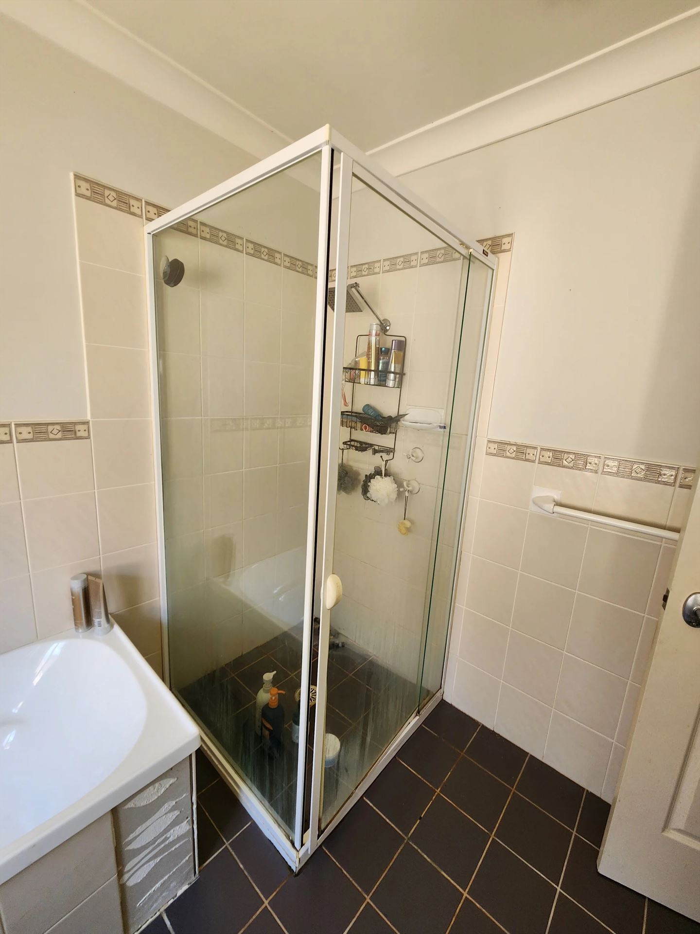 fully shower screen with white hardware installed in Parklea by Showerland
