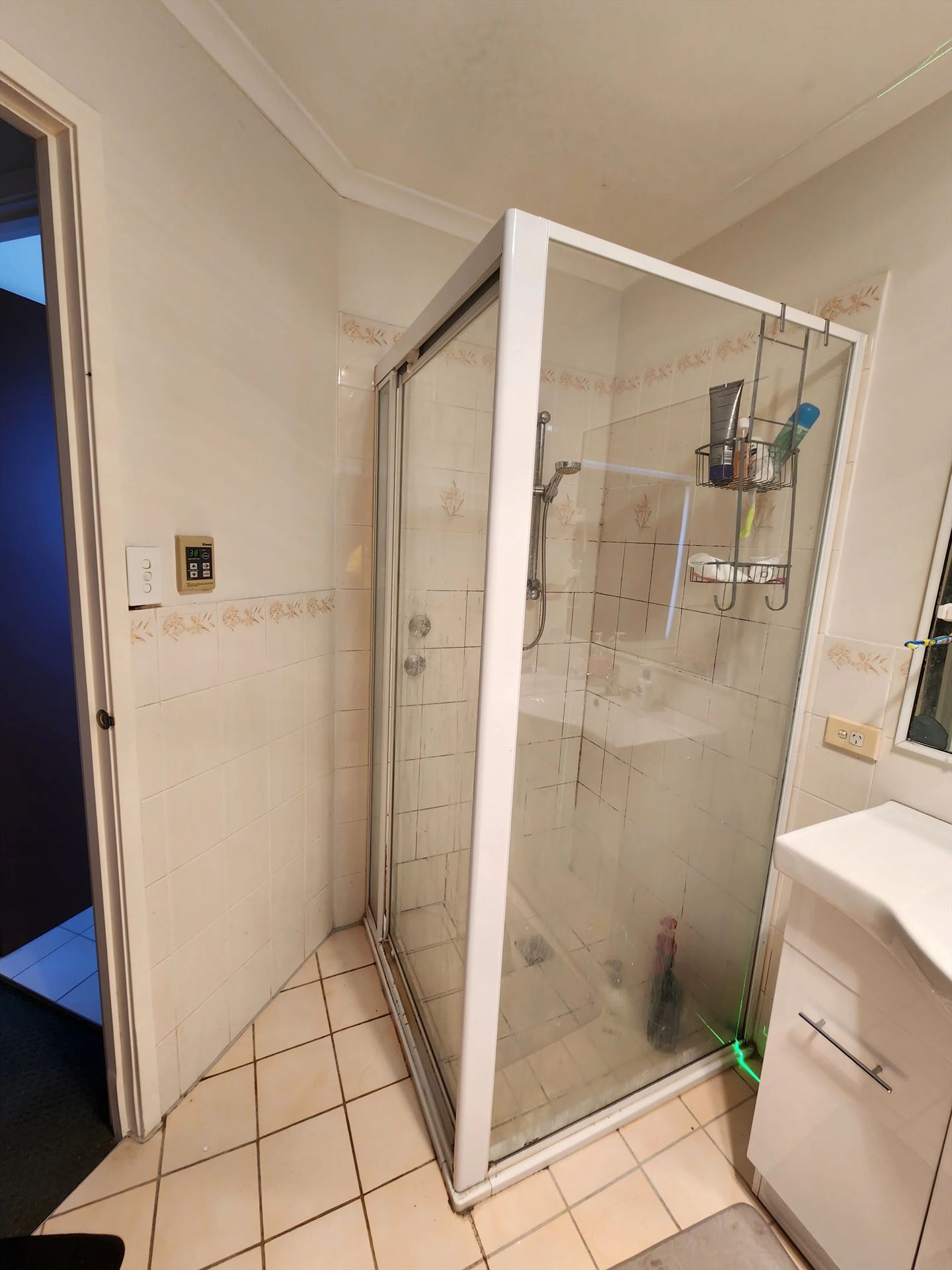 fully shower screen with white hardware installed in Acacia Gardens by Showerland
