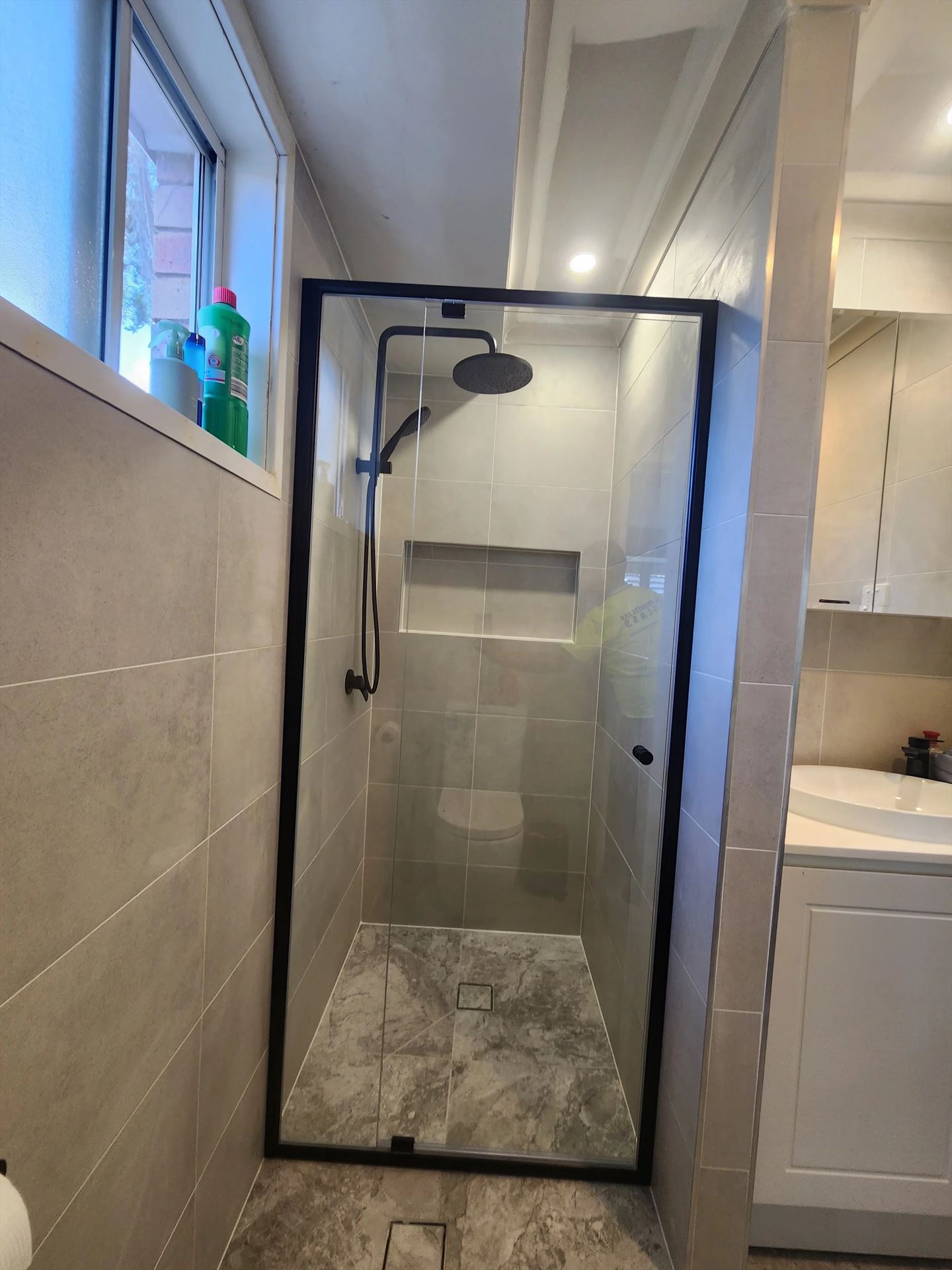 semi shower screen with black hardware installed in Erskine Park by Showerland