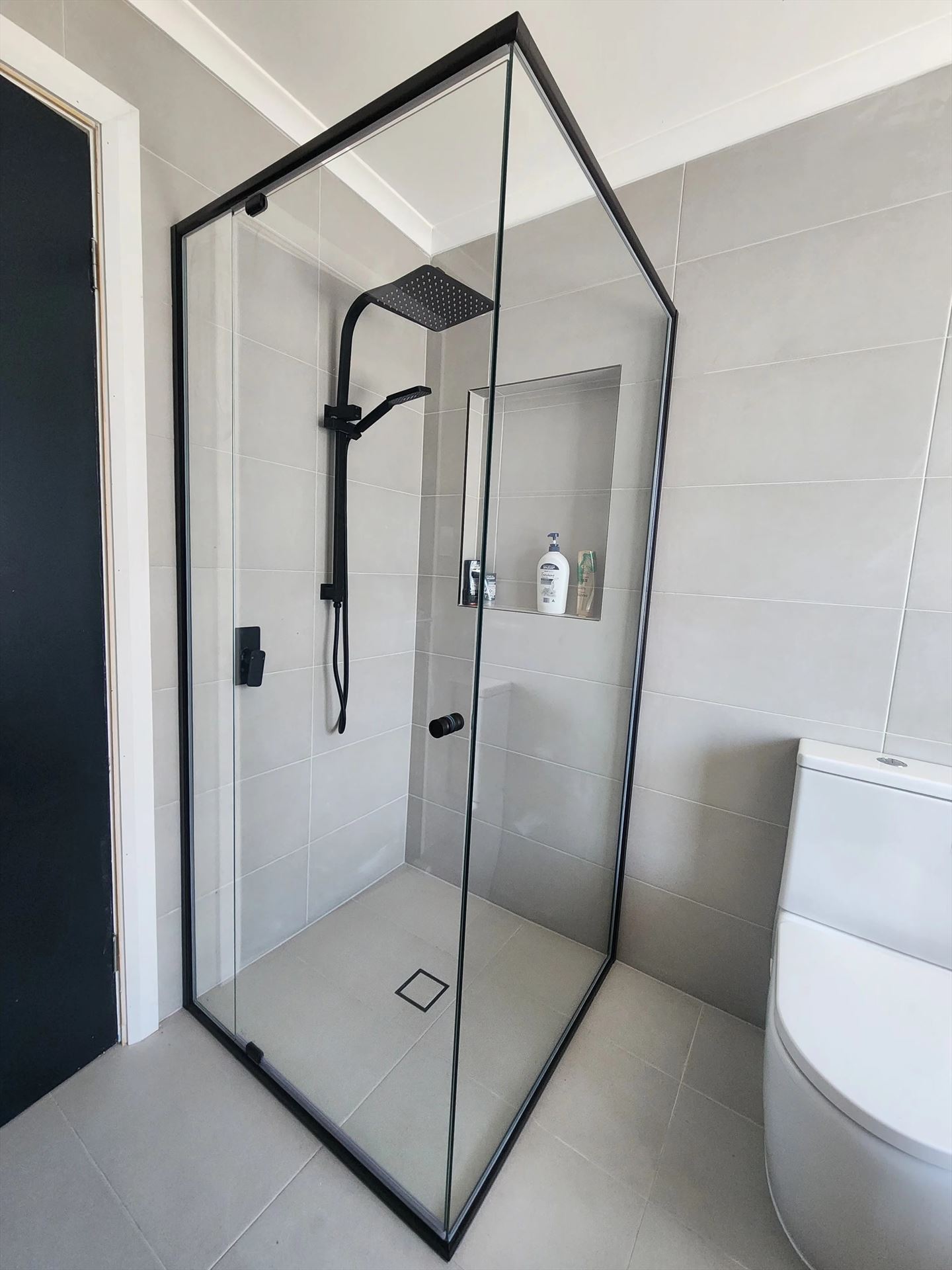 semi shower screen with black hardware installed in The Ponds by Showerland