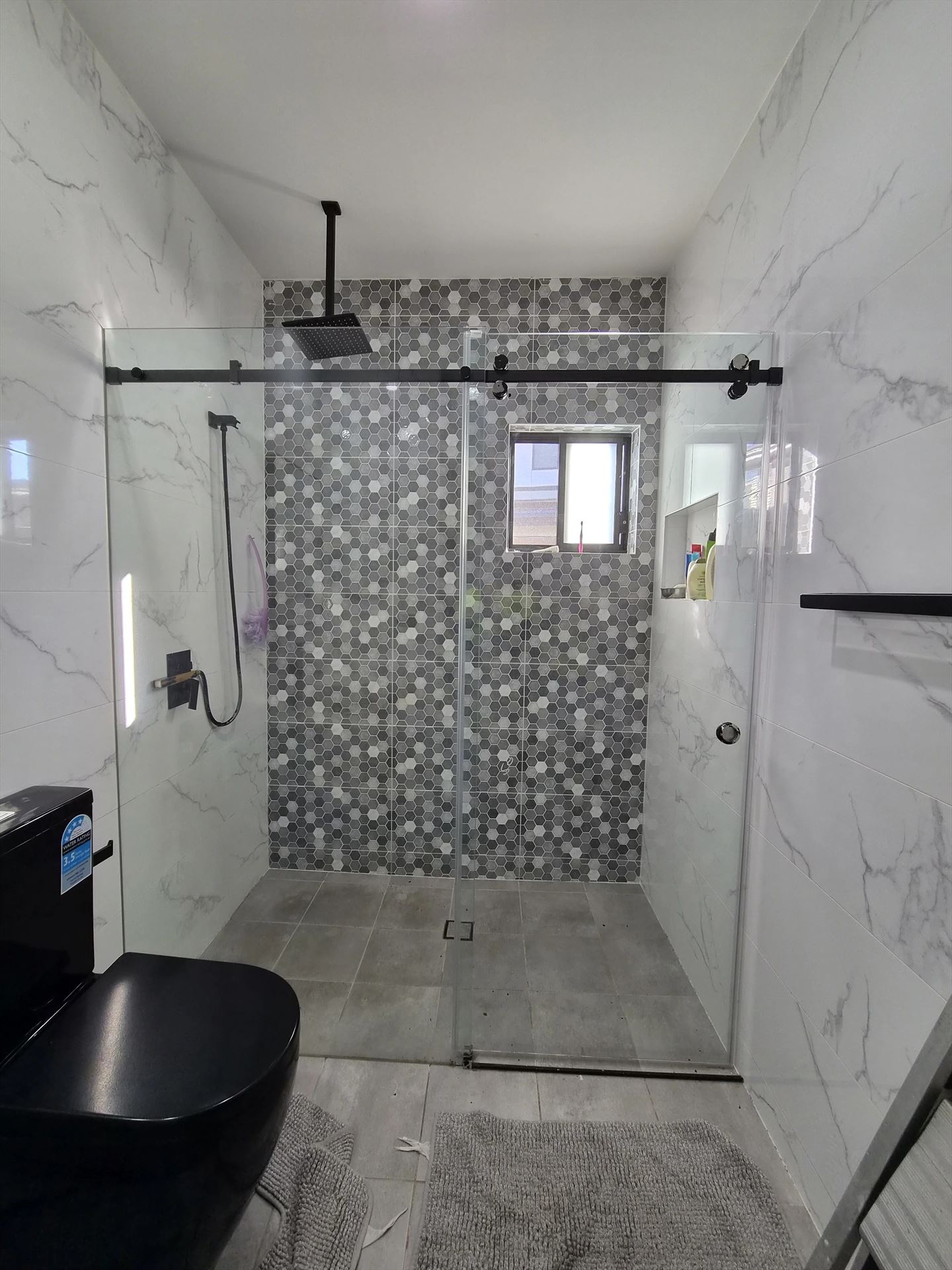 frameless shower screen with black hardware installed in Marsden Park by Showerland