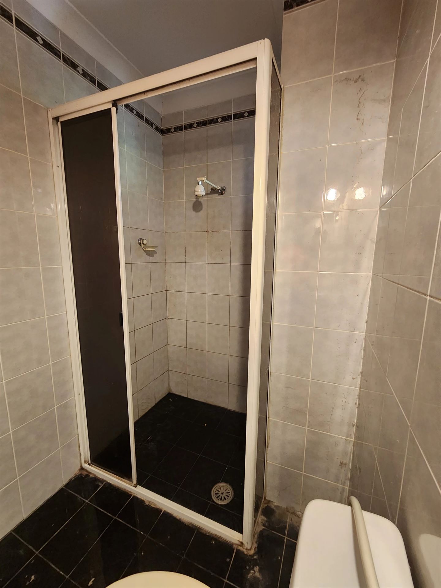 fully shower screen with white hardware installed in Artarmon by Showerland