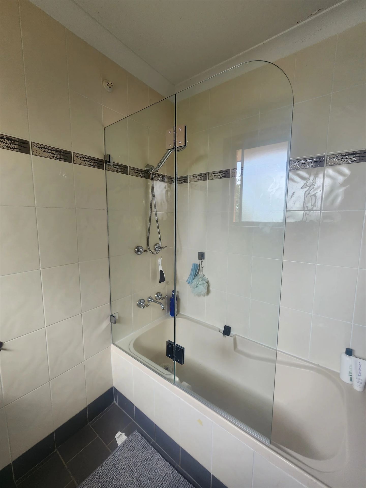 frameless shower screen with chrome hardware installed in Woodcroft by Showerland