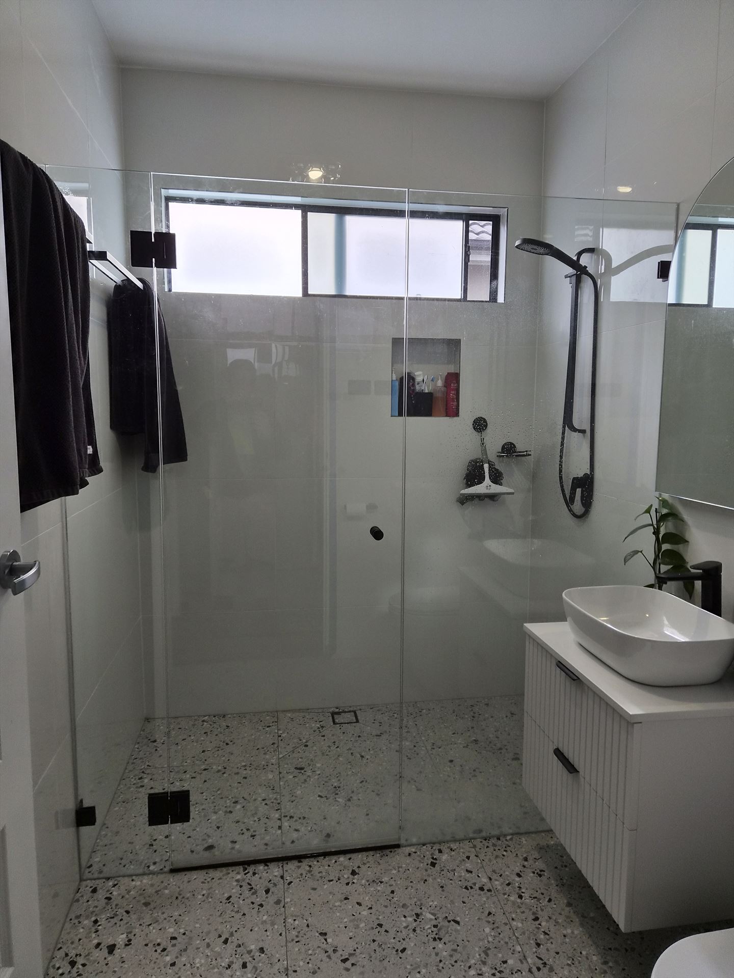 frameless shower screen with black hardware installed in Punchbowl by Showerland
