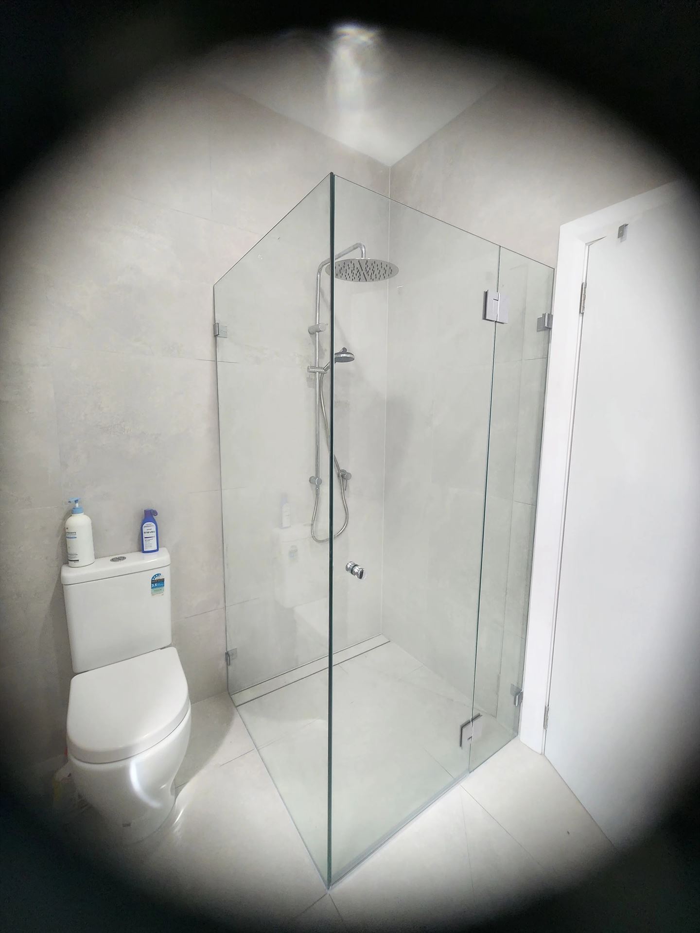 frameless shower screen with chrome hardware installed in Hurlstone Park by Showerland