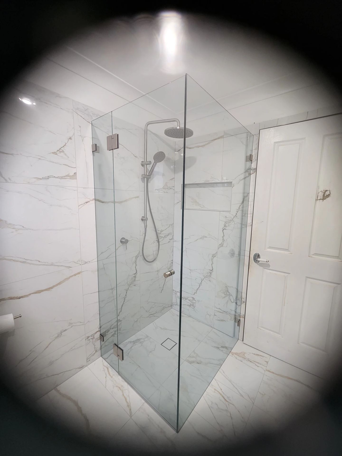 frameless shower screen with chrome hardware installed in Oyster Bay by Showerland