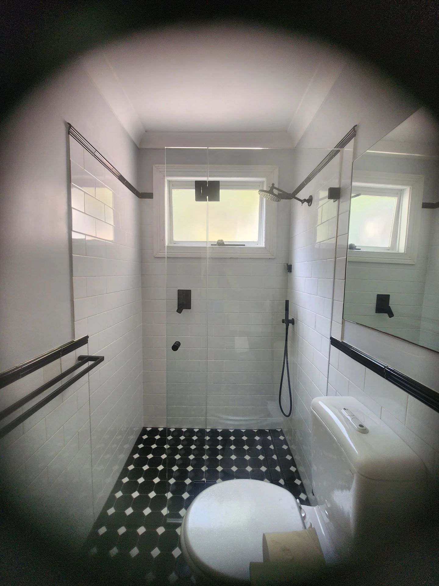 frameless shower screen with black hardware installed in Lilyfield by Showerland