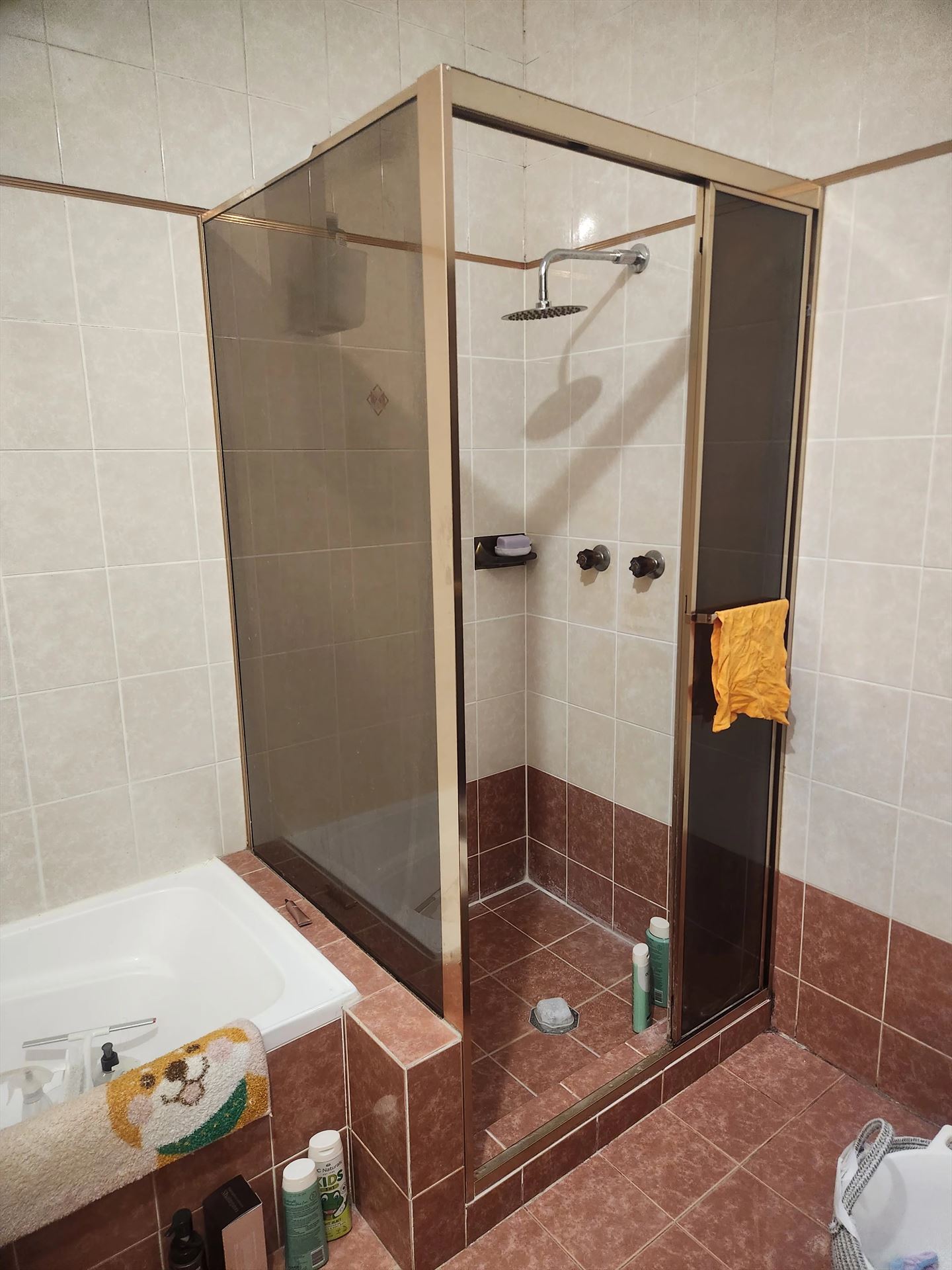fully shower screen with gold hardware installed in West Ryde by Showerland