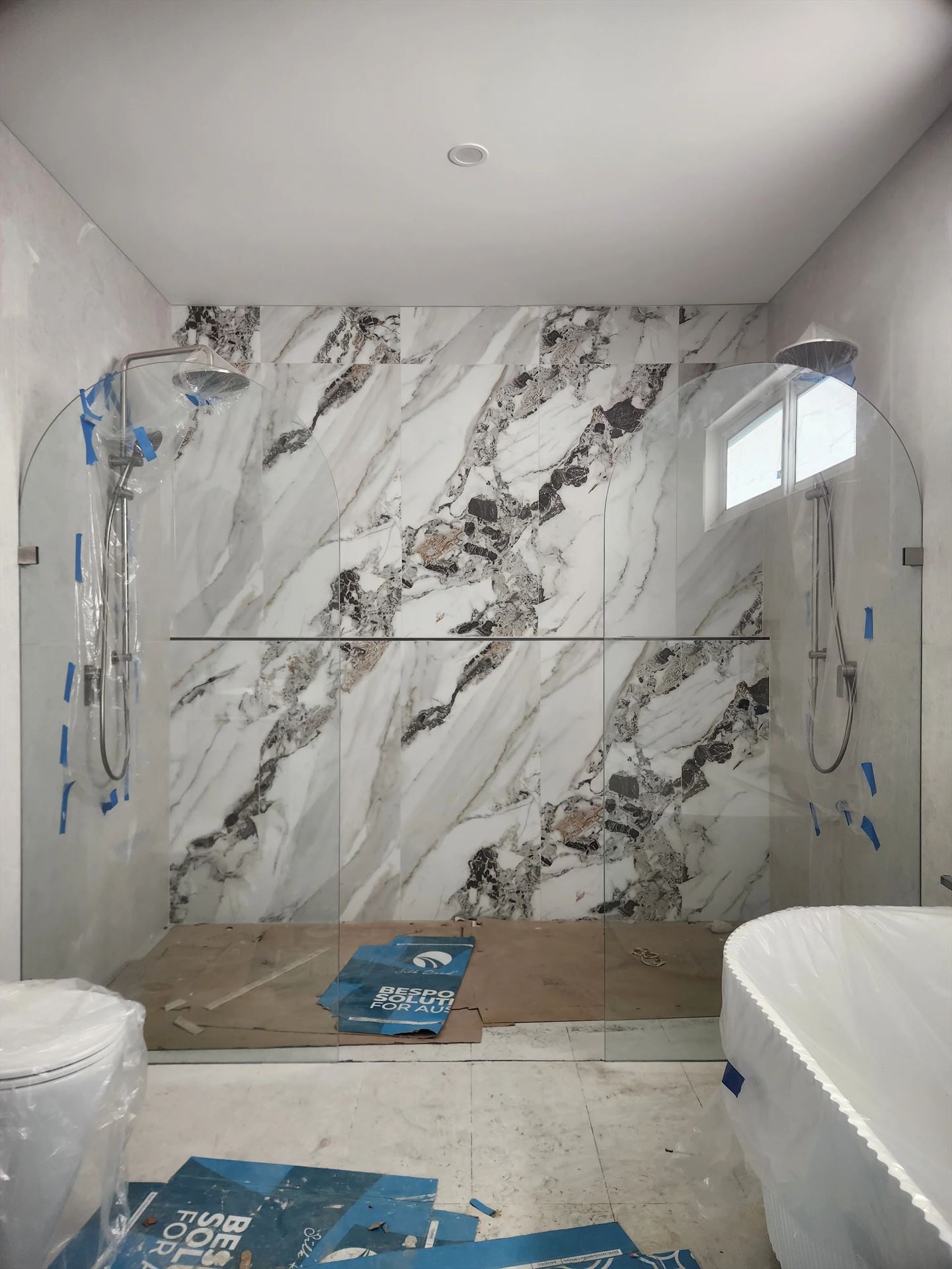 frameless shower screen with chrome hardware installed in Carlingford by Showerland