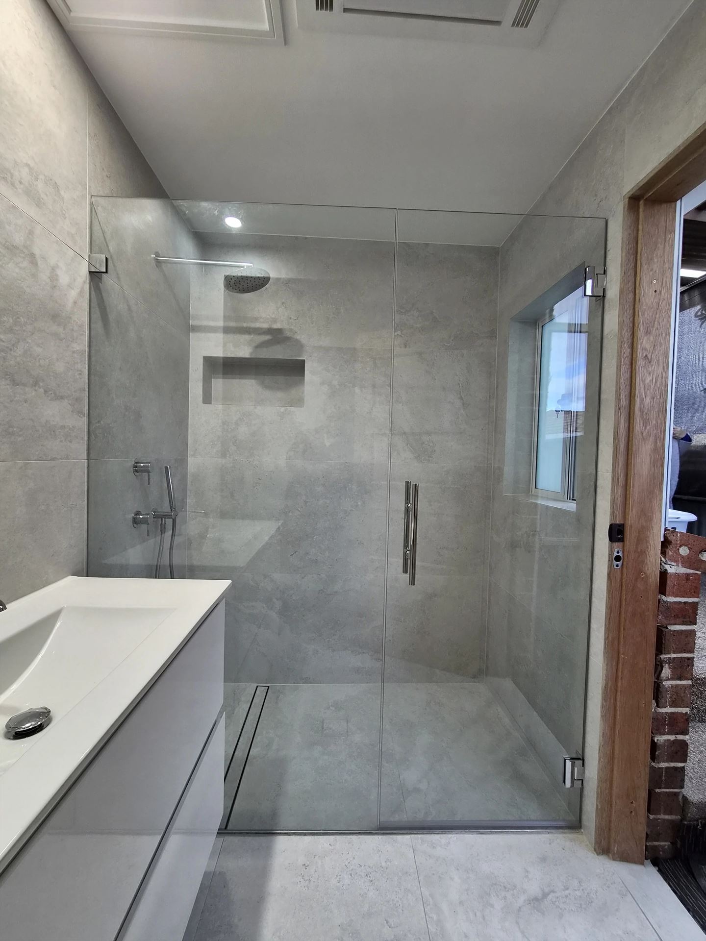 frameless shower screen with chrome hardware installed in Smithfield by Showerland