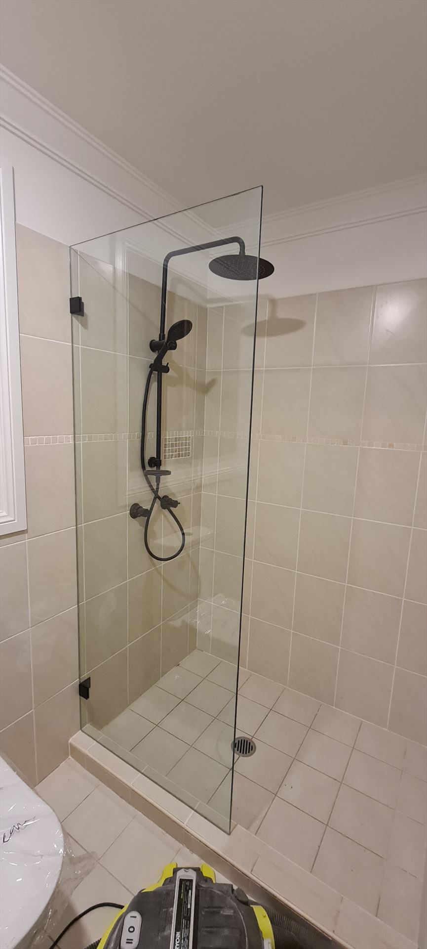 shower screen with black hardware installed in Casula by Showerland