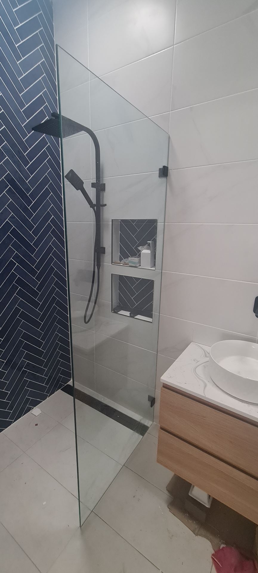 frameless shower screen with black hardware installed in Kingsford by Showerland