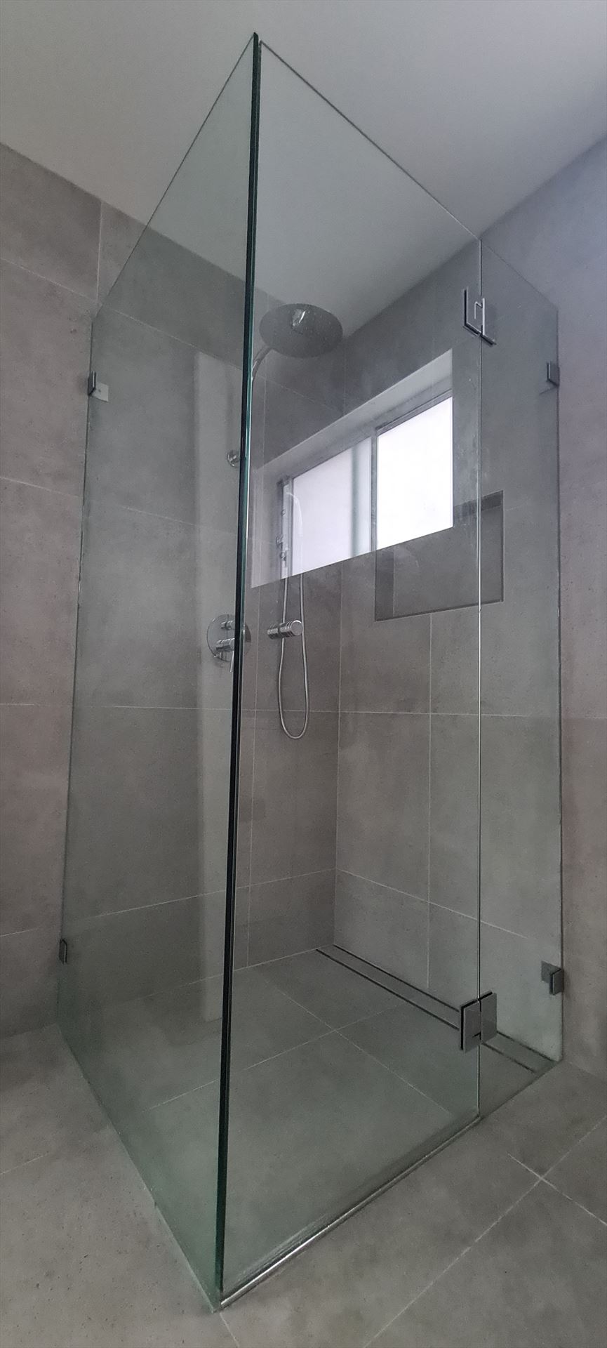 frameless shower screen with chrome hardware installed in Baulkham Hills by Showerland