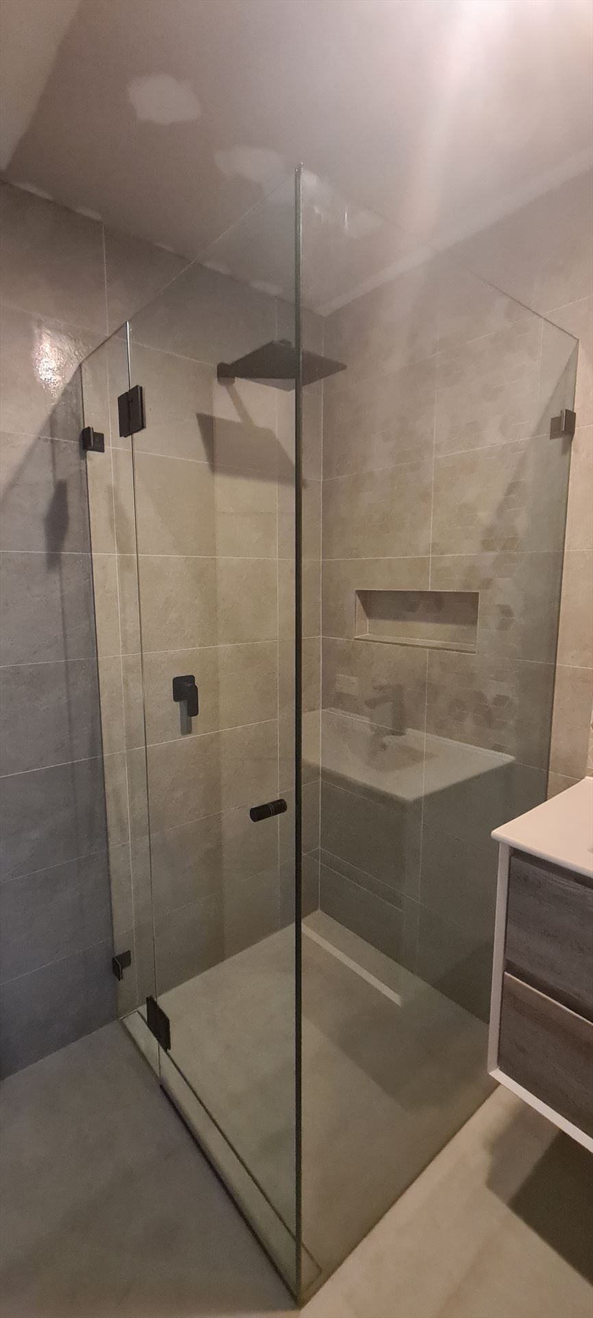 frameless shower screen with black hardware installed in Cherrybrook by Showerland