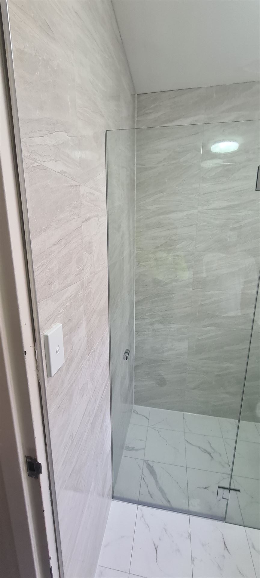 frameless shower screen with chrome hardware installed in Auburn by Showerland